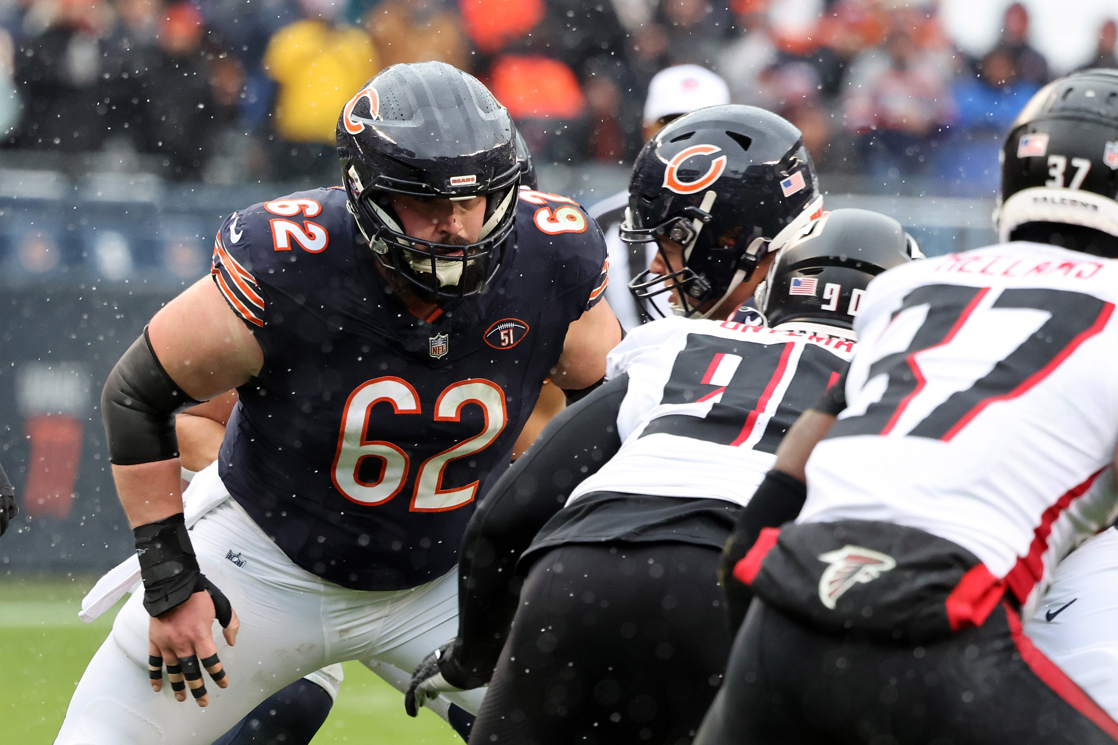 Dec 31, 2023; Chicago, Illinois, USA; Chicago Bears guard Lucas Patrick (62) makes a block against Atlanta Falcons defensive tackle David Onyemata (90) during the first half at Soldier Field.