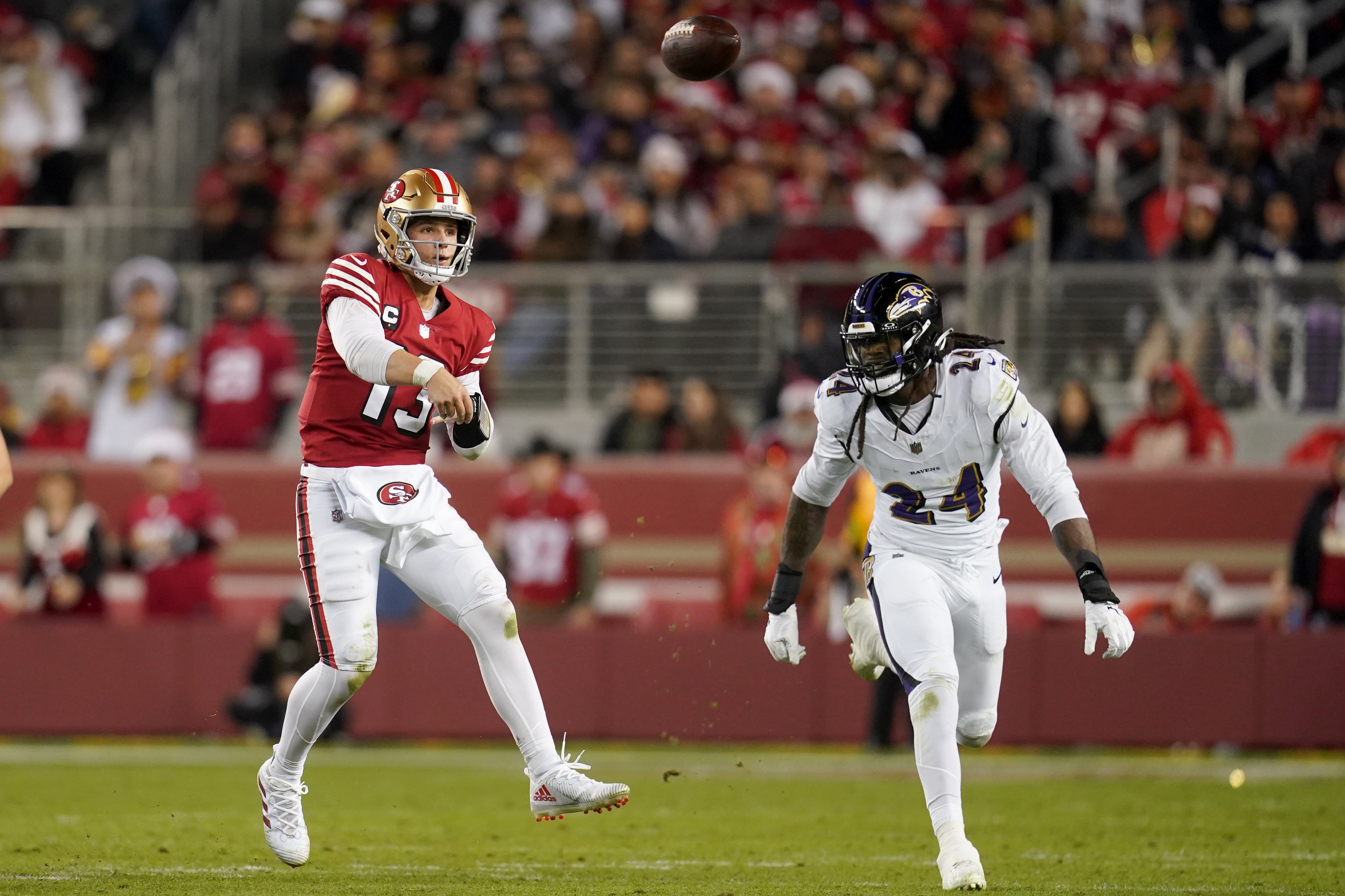 Dec 25, 2023; Santa Clara, California, USA; San Francisco 49ers quarterback Brock Purdy (13) throws a pass in front of Baltimore Ravens linebacker Jadeveon Clowney (24) in the third quarter at Levi's Stadium.
