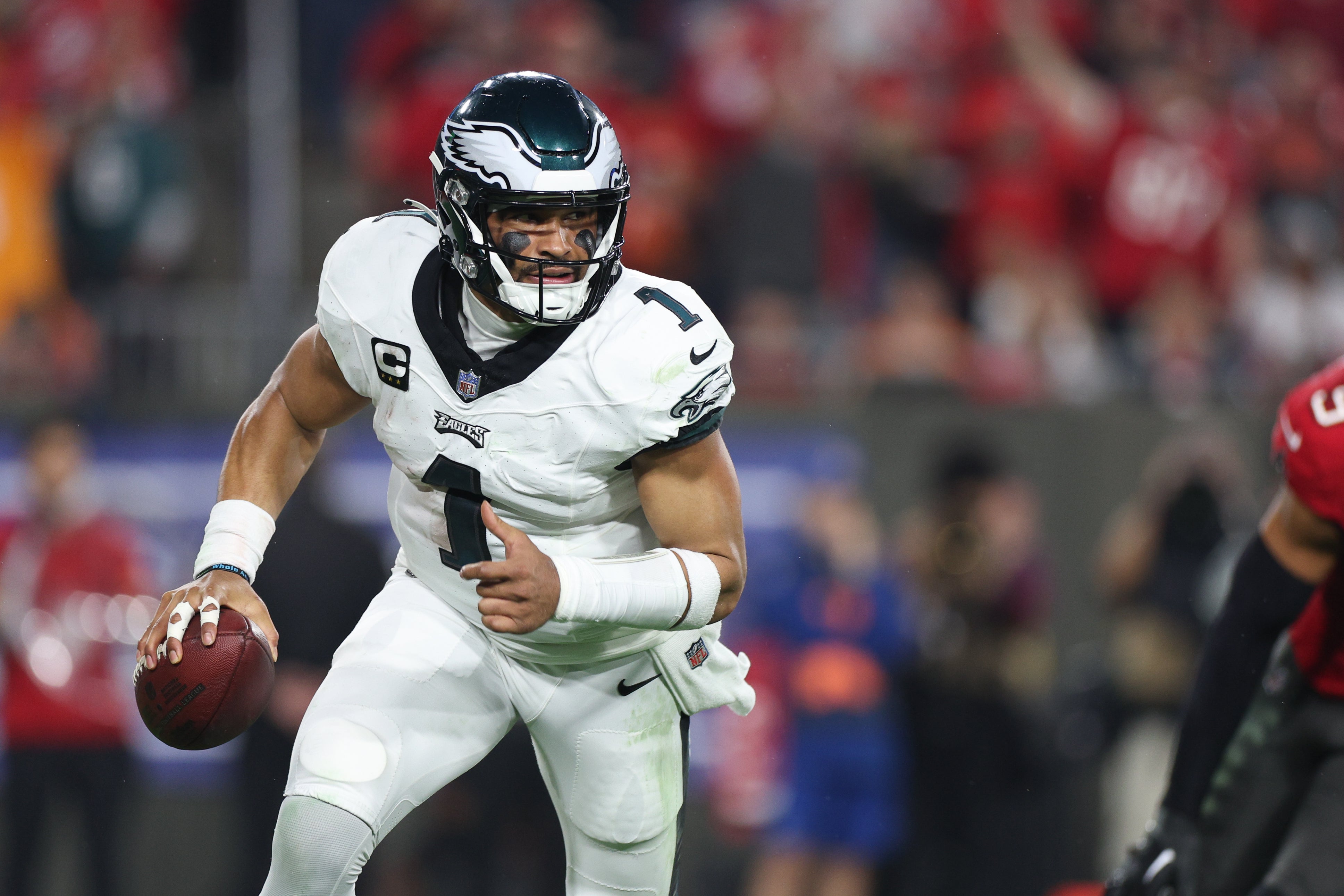 Philadelphia Eagles quarterback Jalen Hurts (1) runs with the ball during the second half of a 2024 NFC wild card game against the Tampa Bay Buccaneers at Raymond James Stadium.