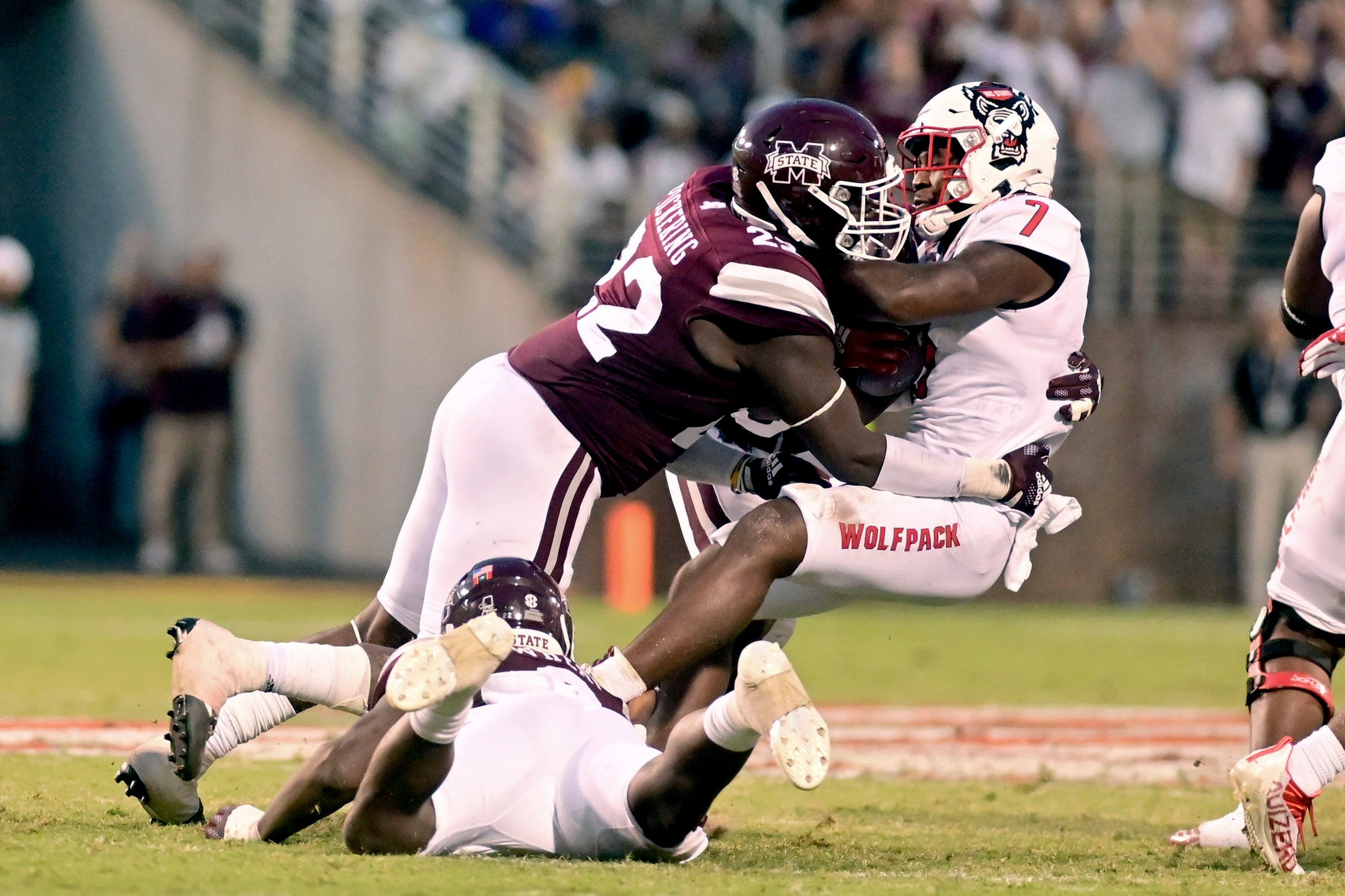 Sep 11, 2021; Starkville, Mississippi, USA; Mississippi State Bulldogs defensive tackle Nathan Pickering (22) tackles North Carolina State Wolfpack running back Zonovan Knight (7) during the second quarter at Davis Wade Stadium at Scott Field.