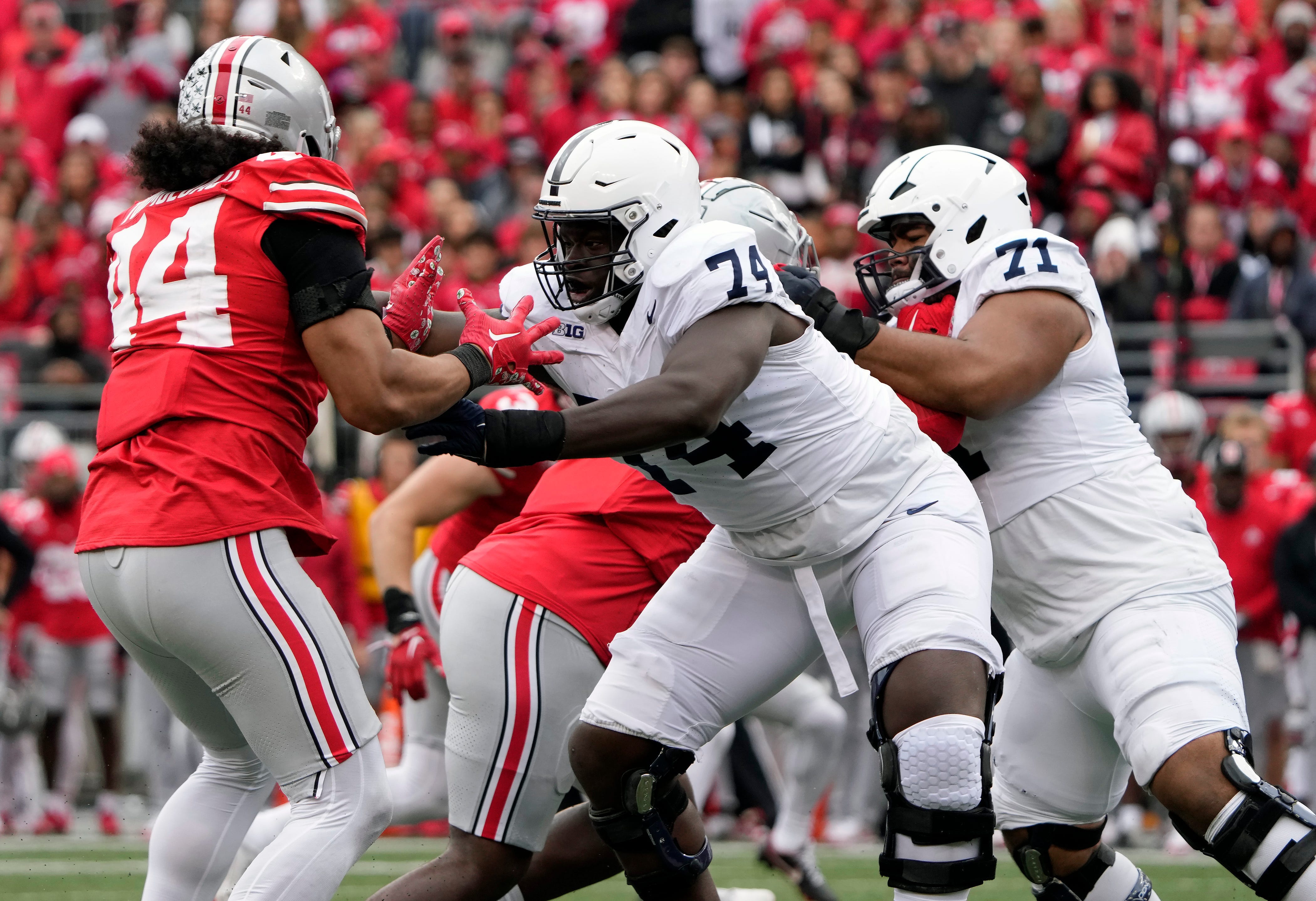 Ohio State Buckeyes defensive end JT Tuimoloau (44) goes up against Penn State Nittany Lions offensive lineman Olumuyiwa Fashanu (74) during the third quarter of their game at Ohio Stadium.