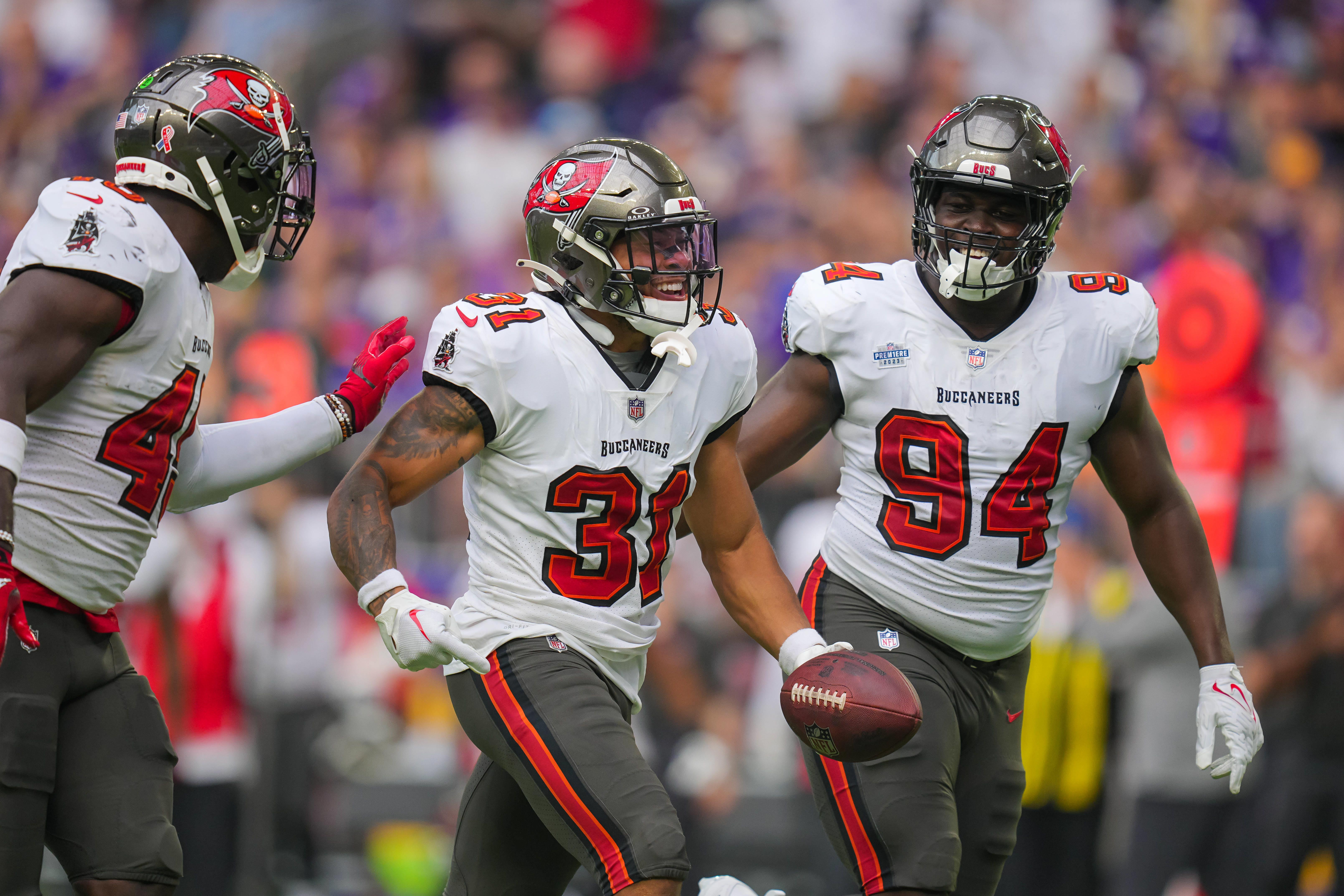 Sep 10, 2023; Minneapolis, Minnesota, USA; Tampa Bay Buccaneers safety Antoine Winfield Jr. (31) celebrates his fumble recovery with defensive tackle Calijah Kancey (94) against the Minnesota Vikings in the first quarter at U.S. Bank Stadium.