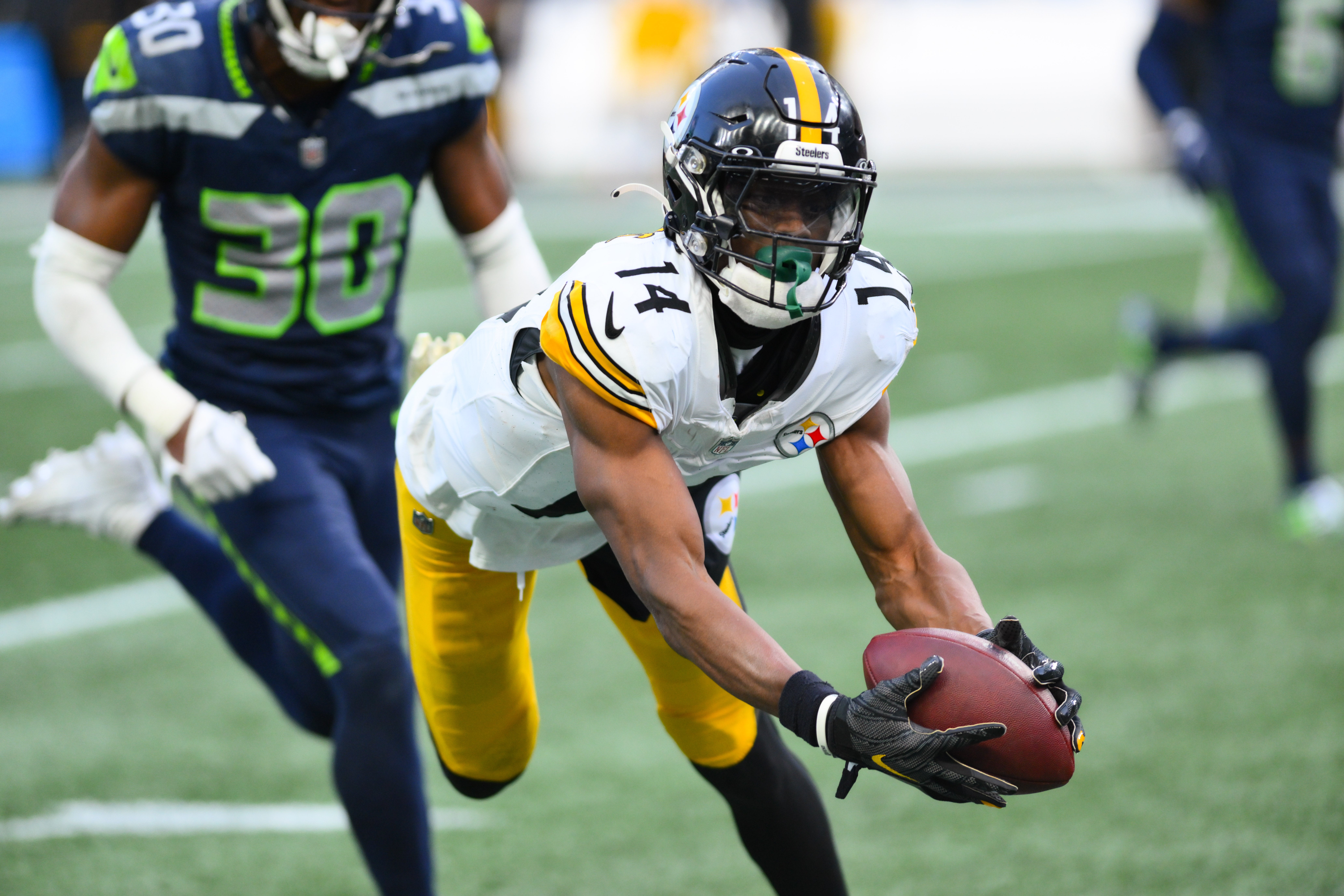 Dec 31, 2023; Seattle, Washington, USA; Pittsburgh Steelers wide receiver George Pickens (14) catches a pass against the Seattle Seahawks during the second half at Lumen Field. Mandatory Credit: Steven Bisig-USA TODAY Sports