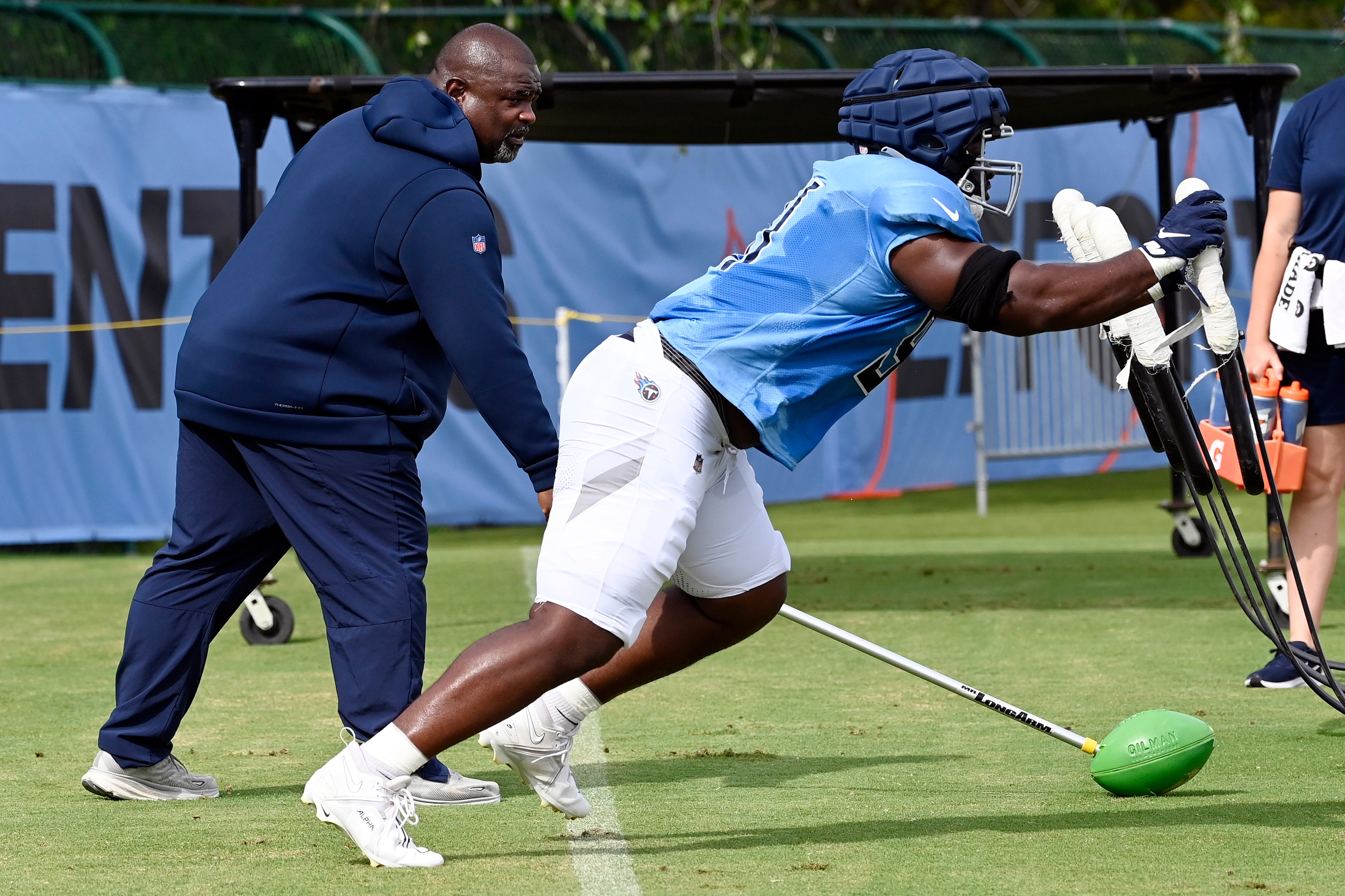 Tennessee Titans defensive line coach Terrell Williams watches defensive tackle Shakel Brown, right, run through a drill during an NFL football training camp practice Tuesday, August 8, 2023, in Nashville, Tenn. Williams will be the Titans head coach for the preseason opener against the Chicago Bears.