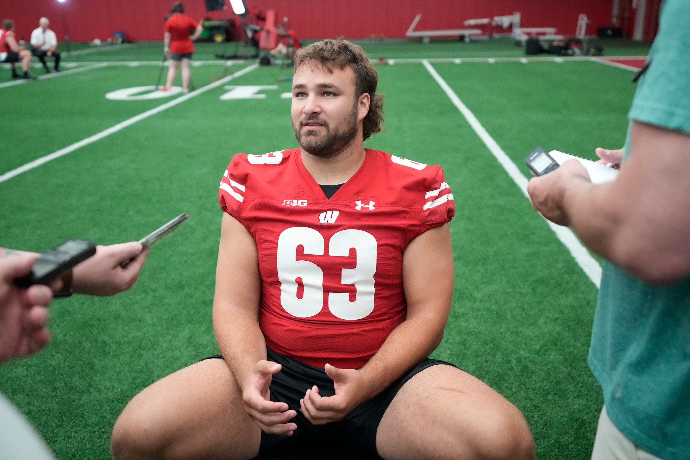 Wisconsin Badgers offensive lineman Tanor Bortolini (63) answers questions during Wisconsin Badgers football media day at Camp Randall Stadium in Madison on Tuesday, Aug. 1, 2023.