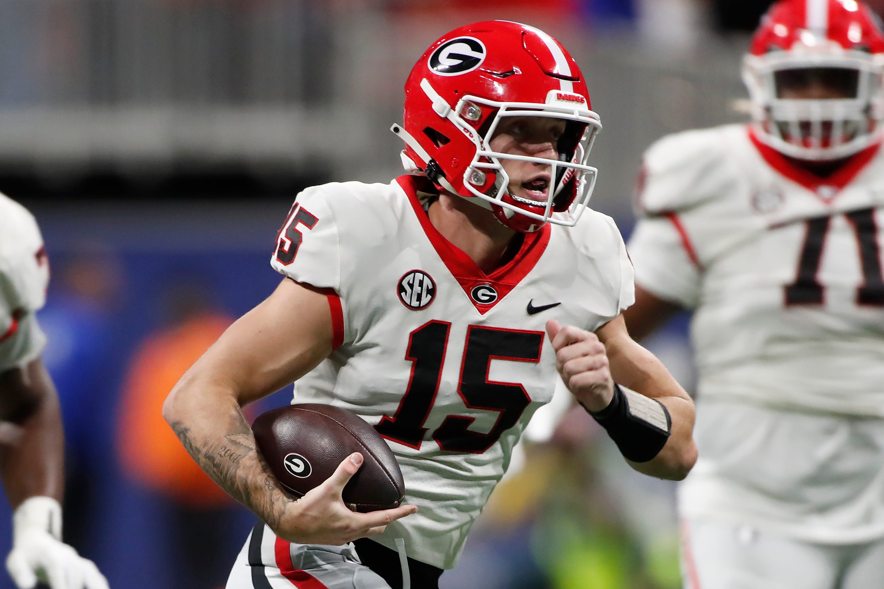Georgia quarterback Carson Beck (15) runs the ball during the first half of the SEC Championship game against Alabama at Mercedes-Benz Stadium in Atlanta.
