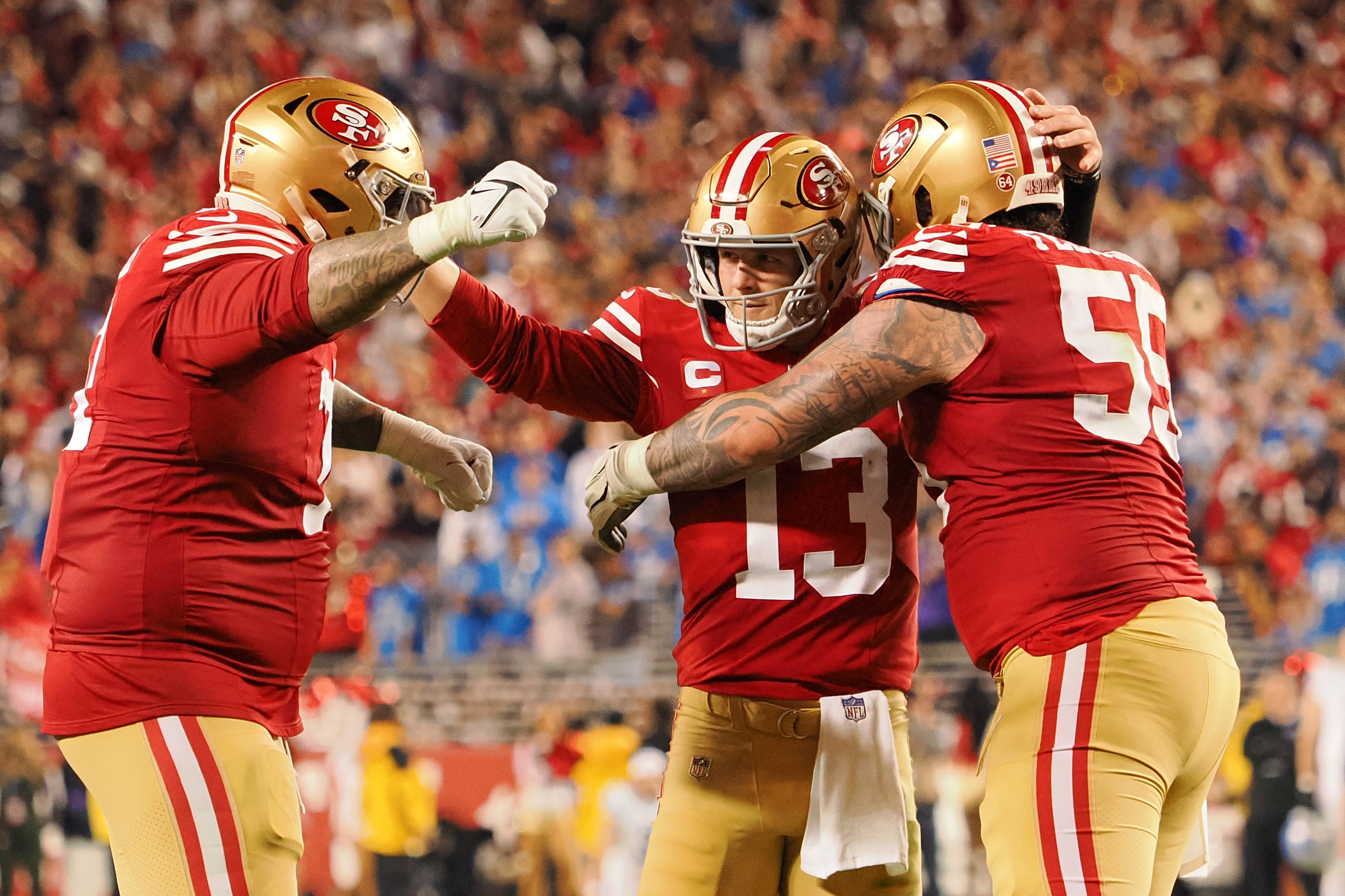 Jan 28, 2024; Santa Clara, California, USA; San Francisco 49ers quarterback Brock Purdy (13) celebrates with guard Jon Feliciano (55) and offensive tackle Trent Williams (71) after a play against the Detroit Lions during the second half of the NFC Championship football game at Levi's Stadium.