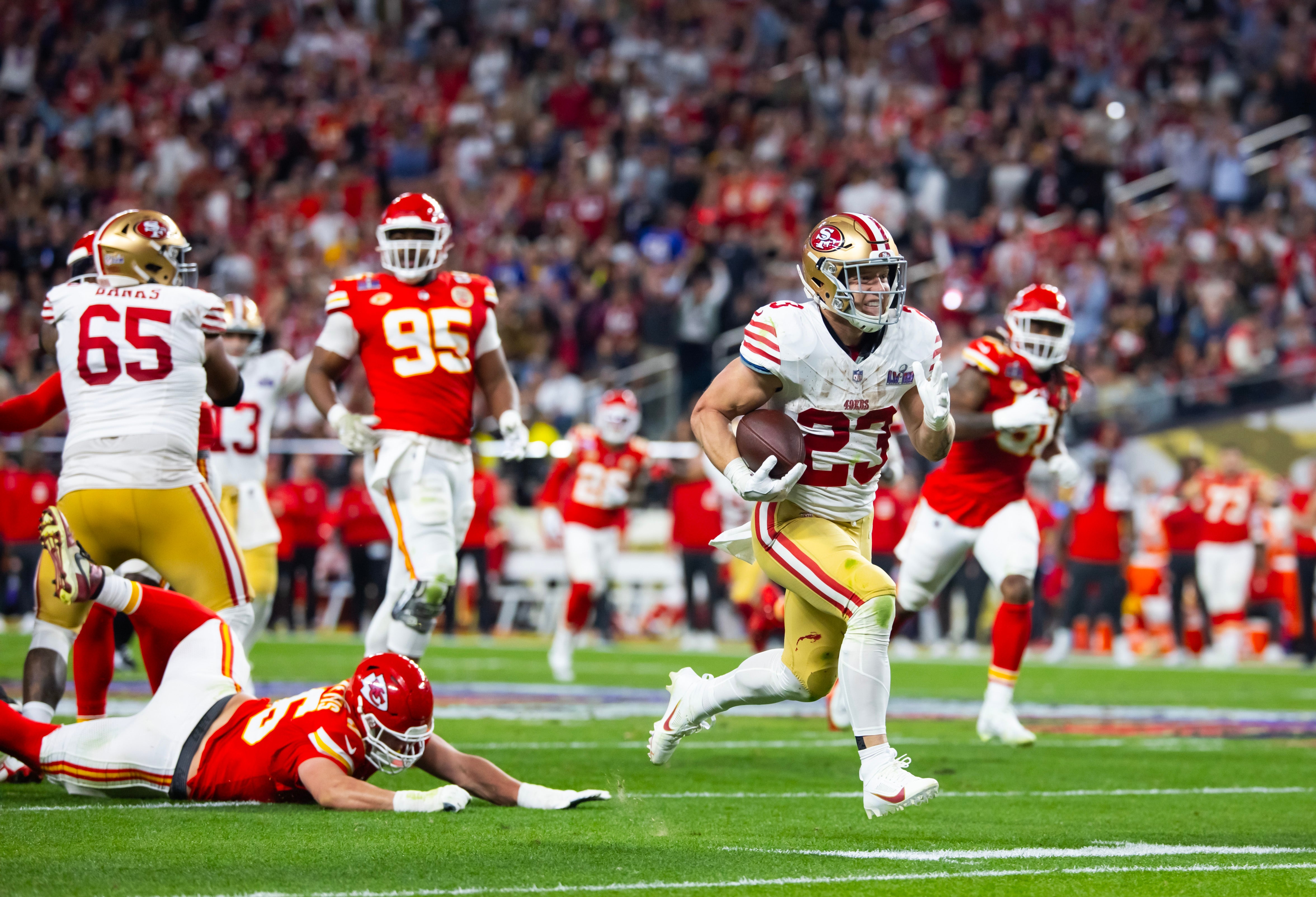 Feb 11, 2024; Paradise, Nevada, USA; San Francisco 49ers running back Christian McCaffrey (23) scores a touchdown in the first half of Super Bowl LVIII at Allegiant Stadium.