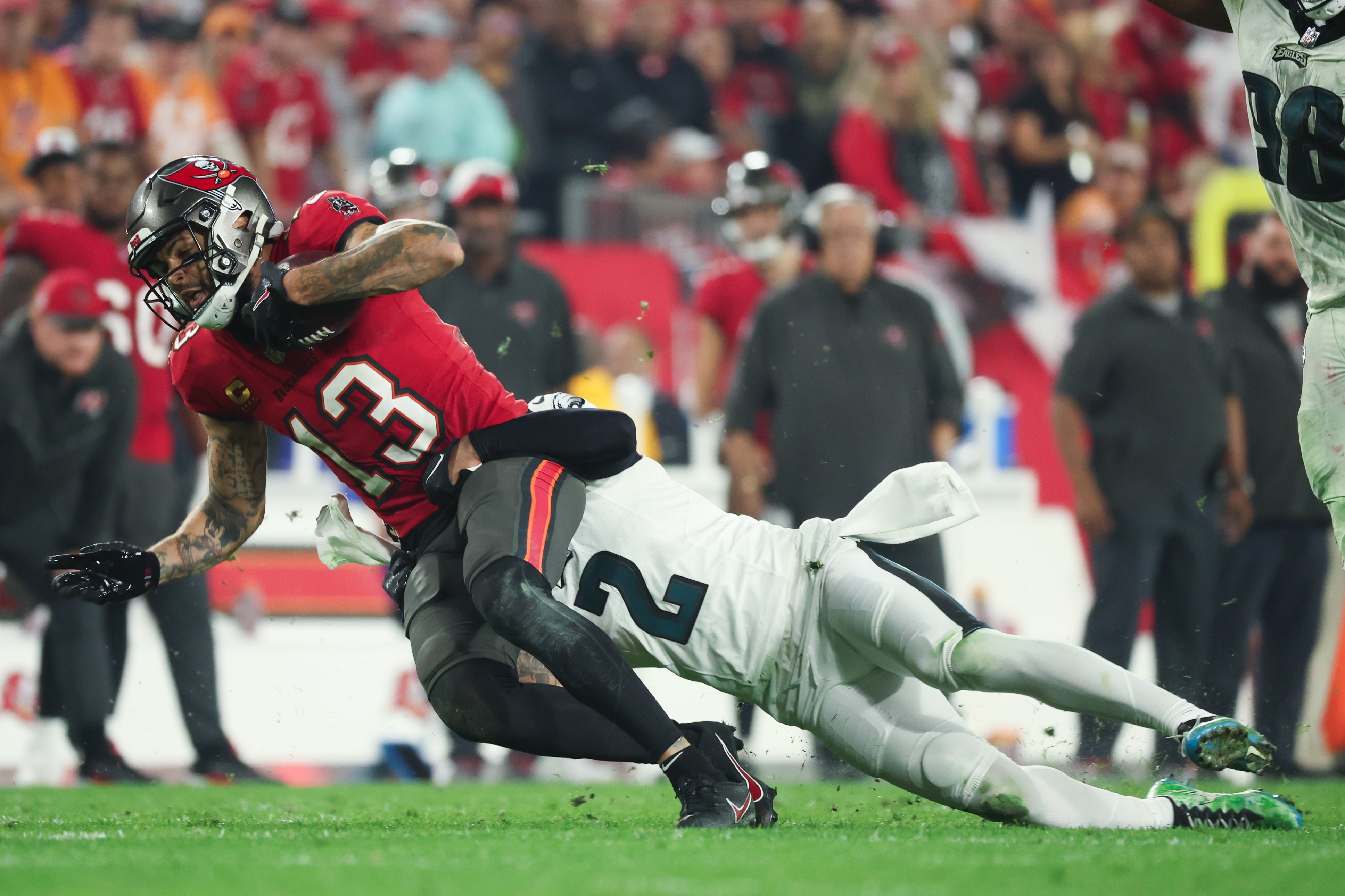 Tampa Bay Buccaneers wide receiver Mike Evans (13) is tackled by Philadelphia Eagles cornerback Darius Slay (2) during the second half of a 2024 NFC wild card game at Raymond James Stadium.