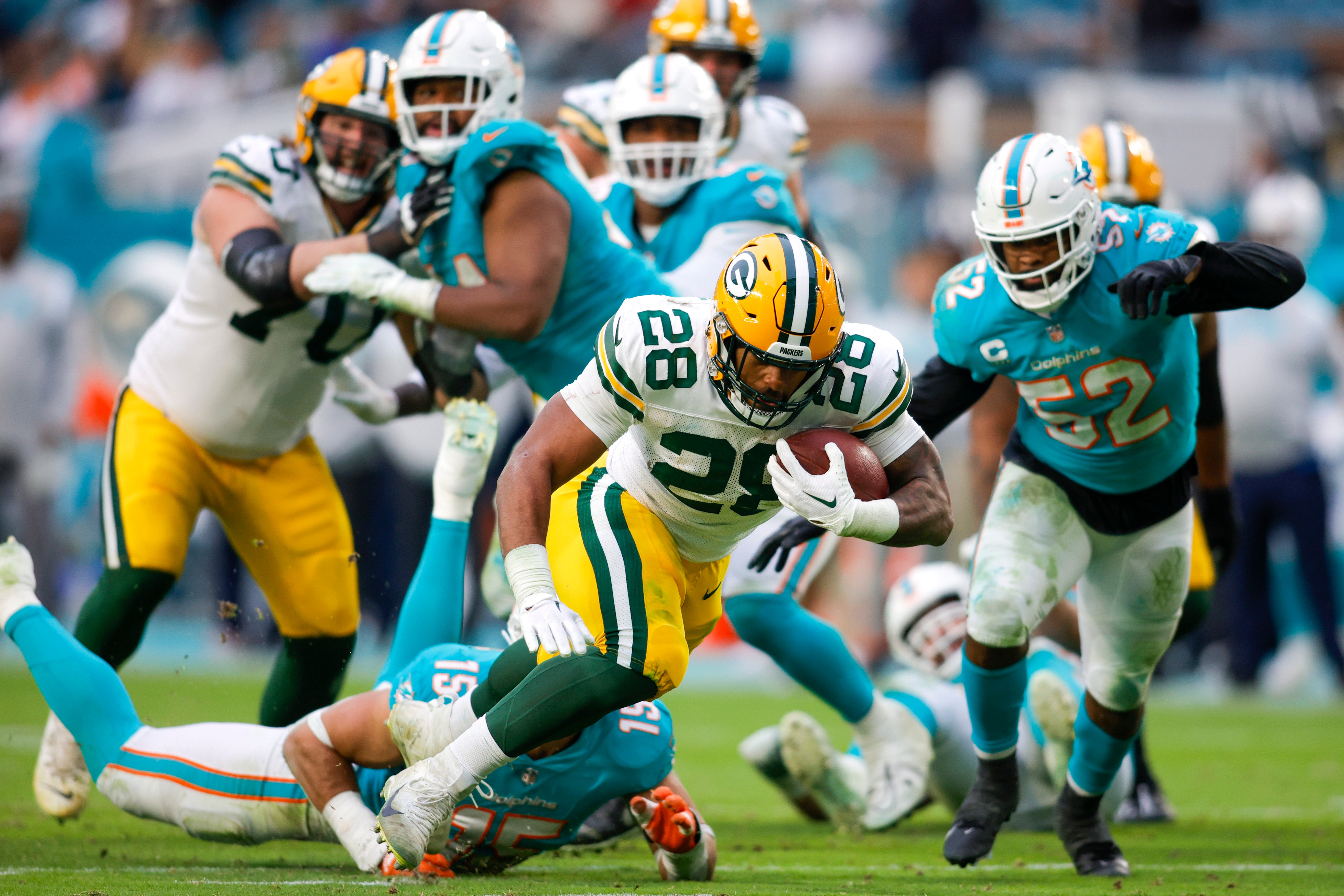 Dec 25, 2022; Miami Gardens, Florida, USA; Green Bay Packers running back AJ Dillon (28) runs with the football during the fourth quarter against the Miami Dolphins at Hard Rock Stadium.