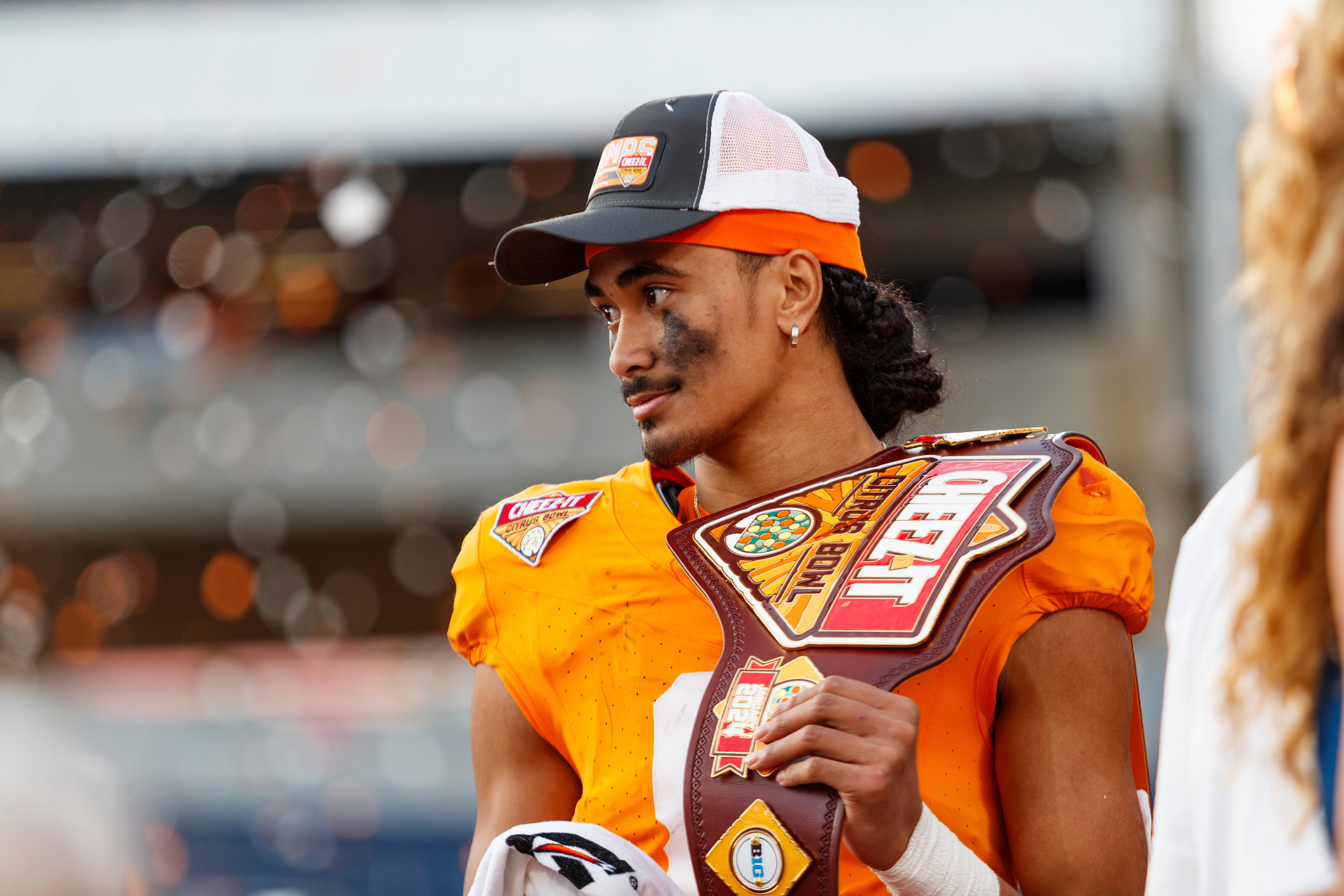 Jan 1, 2024; Orlando, FL, USA; Tennessee Volunteers quarterback Nico Iamaleava (8) poses with the MVP Trophy after defeating the Iowa Hawkeyes at Camping World Stadium.