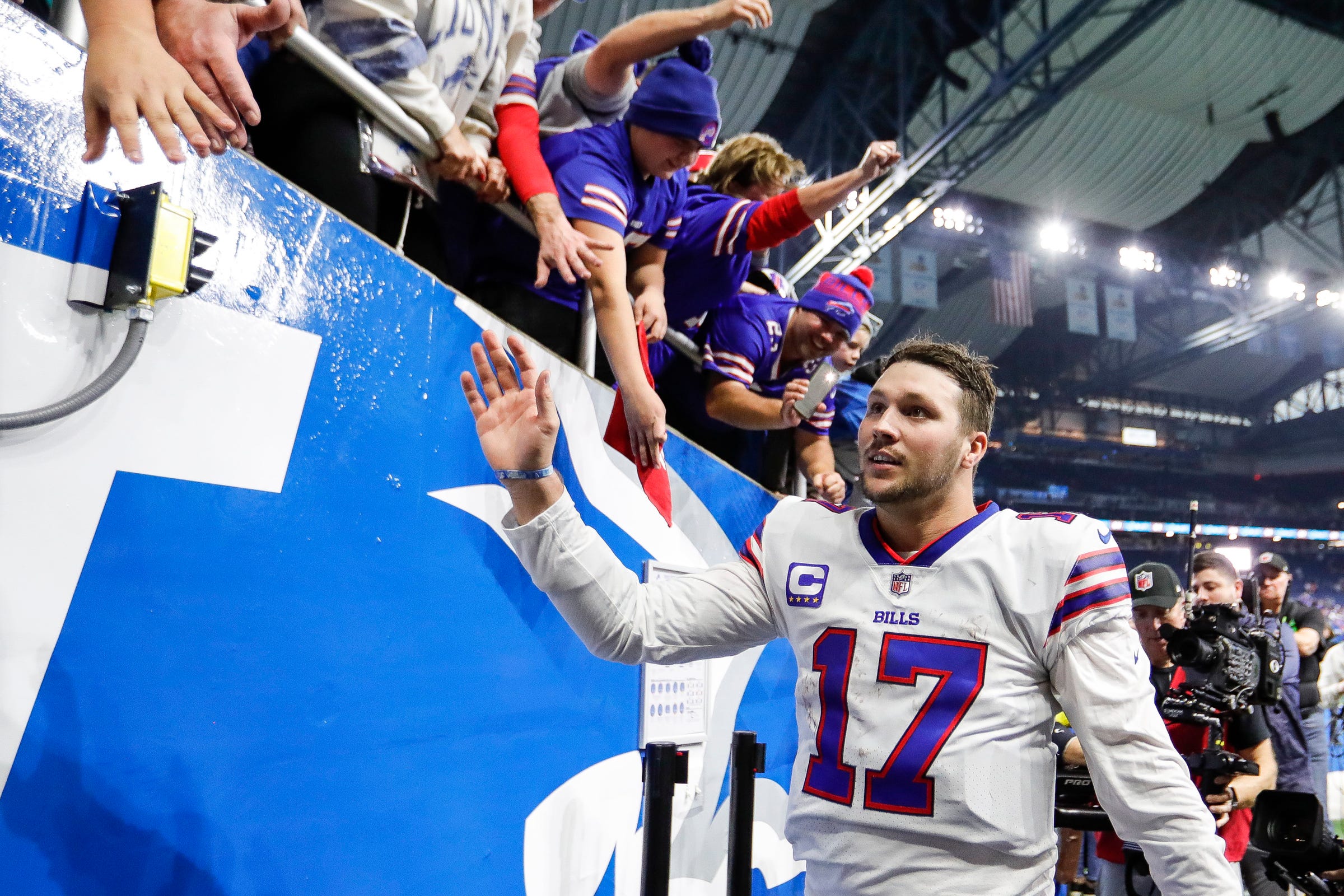 Buffalo Bills quarterback Josh Allen (17) high fives fans after the Bills defeated the Detroit Lions 28-25 at Ford Field in Detroit on Thursday, Nov. 24, 2022.
