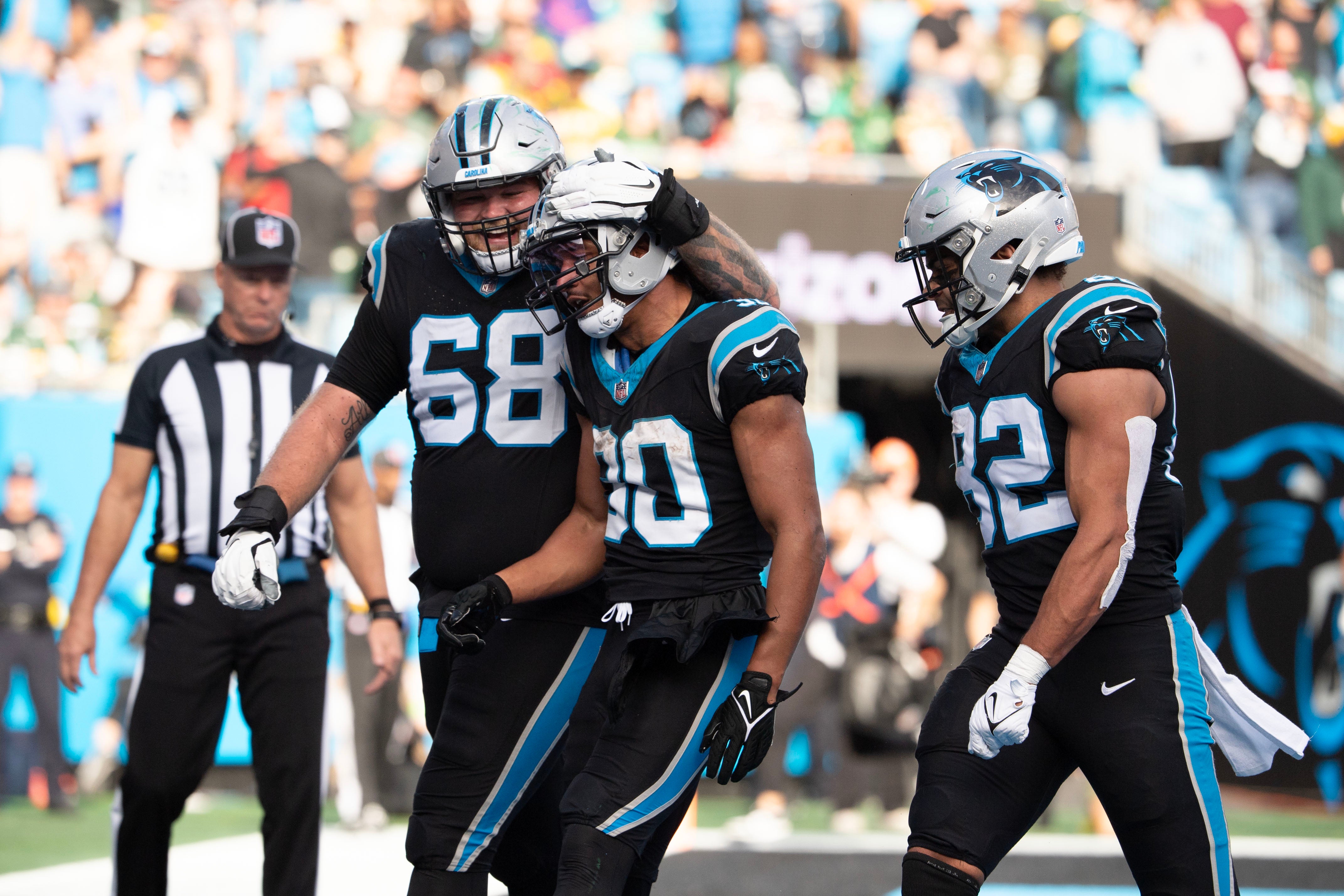 Dec 24, 2023; Charlotte, North Carolina, USA; Carolina Panthers running back Chuba Hubbard (30) with guard Cade Mays (68) and tight end Tommy Tremble (82) after scoring a touchdown in the third quarter at Bank of America Stadium. Mandatory Credit: Bob Donnan-USA TODAY Sports