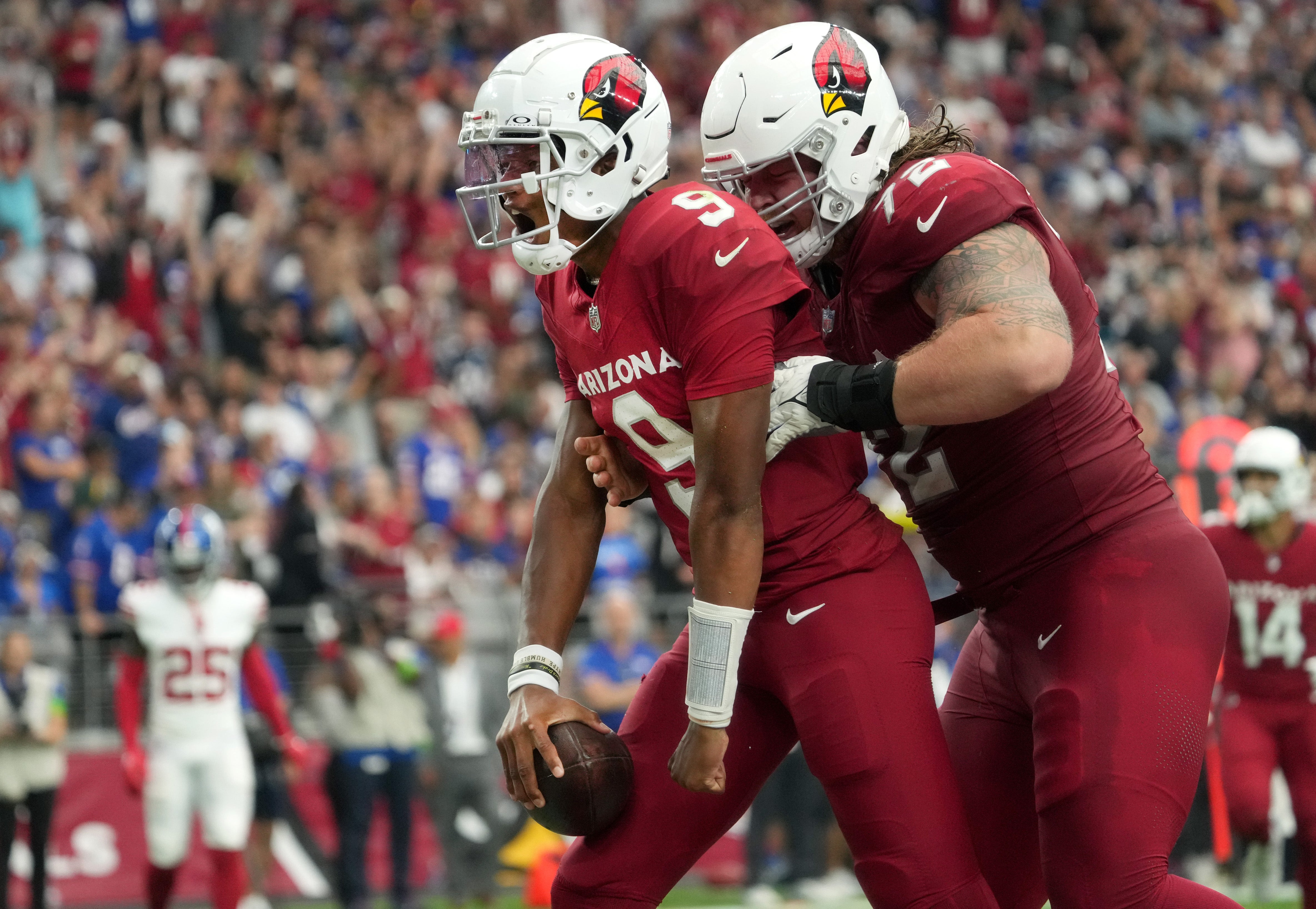 Sep 17, 2023; Glendale, Arizona, USA; Arizona Cardinals quarterback Joshua Dobbs (9) celebrates his rushing touchdown with teammate Hjalte Froholdt (72) against the New York Giants at State Farm Stadium. Mandatory Credit: Joe Rondone-USA TODAY Sports