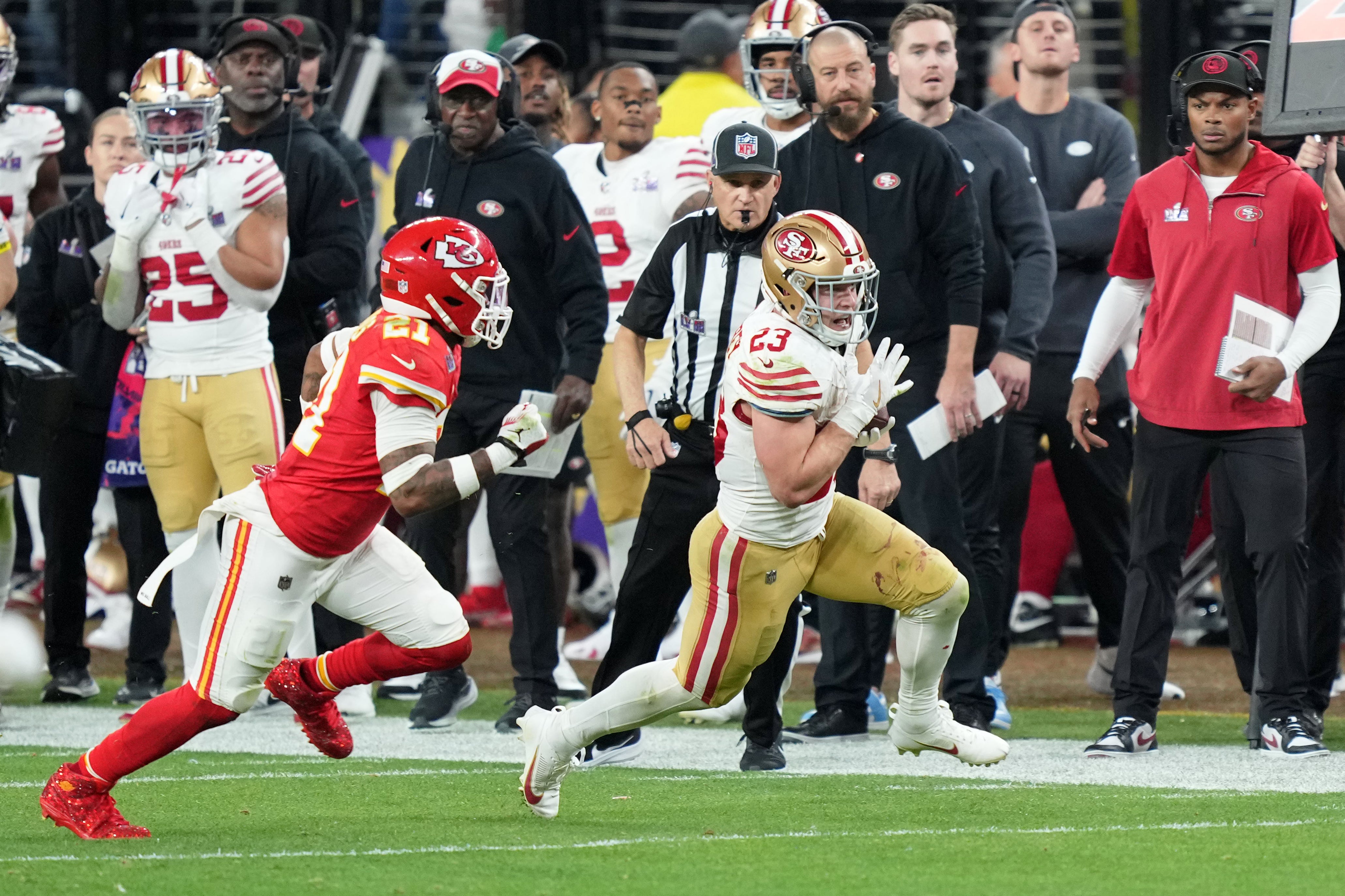 Feb 11, 2024; Paradise, Nevada, USA; San Francisco 49ers running back Christian McCaffrey (23) runs with the ball against Kansas City Chiefs safety Mike Edwards (21) during overtime of Super Bowl LVIII at Allegiant Stadium.