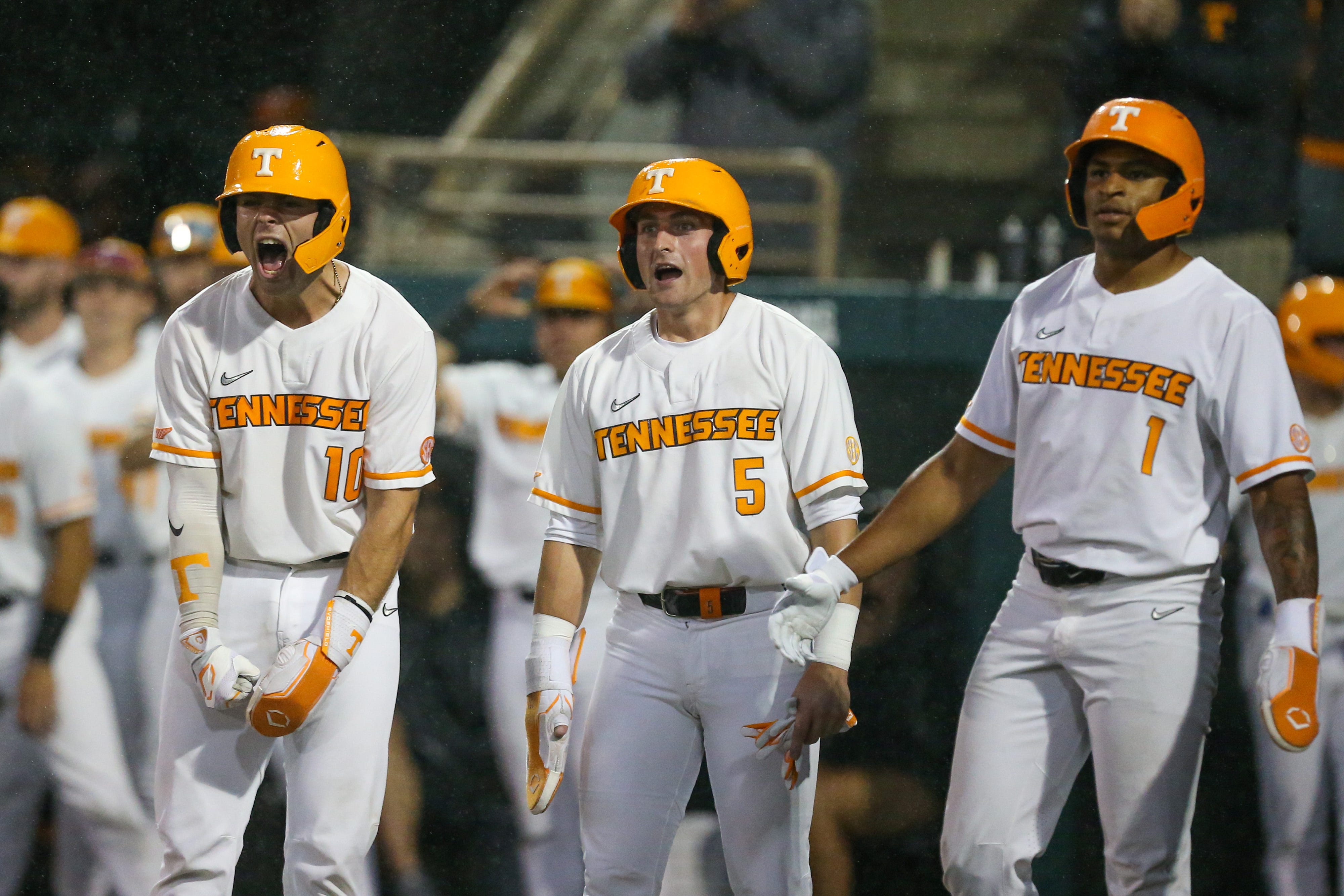 Tennessee Volunteers catcher Cal Stark (10), catcher Cannon Peebles (5), and infielder Christian Moore (1) wait to congratulate first baseman Blake Burke (25) during the game against the South Carolina Gamecocks at Lindsey Nelson Stadium in Knoxville, Tenn., Friday, May 17, 2024.