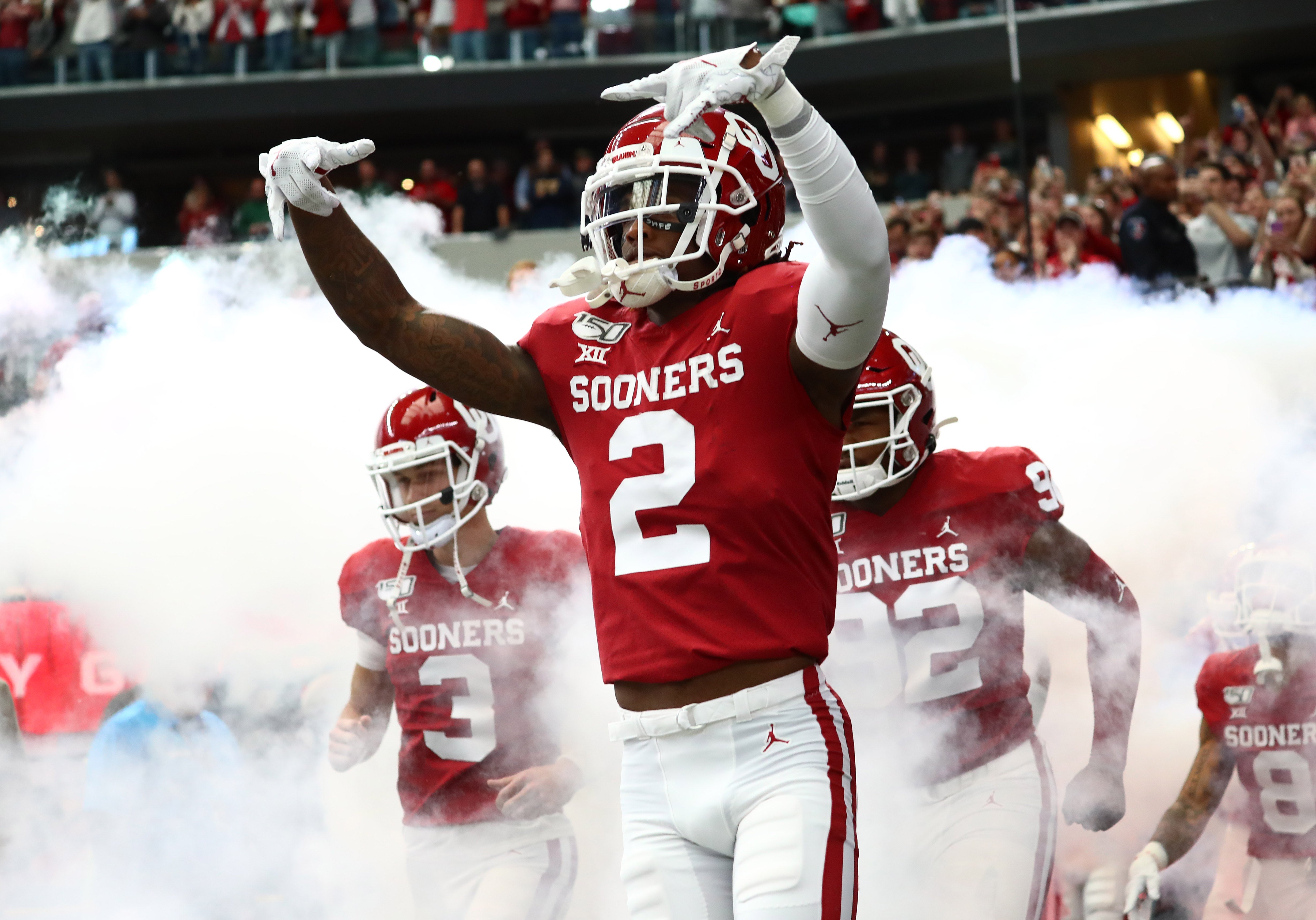 Oklahoma Sooner receiver CeeDee Lamb (2) takes the field prior to the game flashing the horns down signal against the Baylor Bears in the 2019 Big 12 Championship Game at AT&T Stadium.
