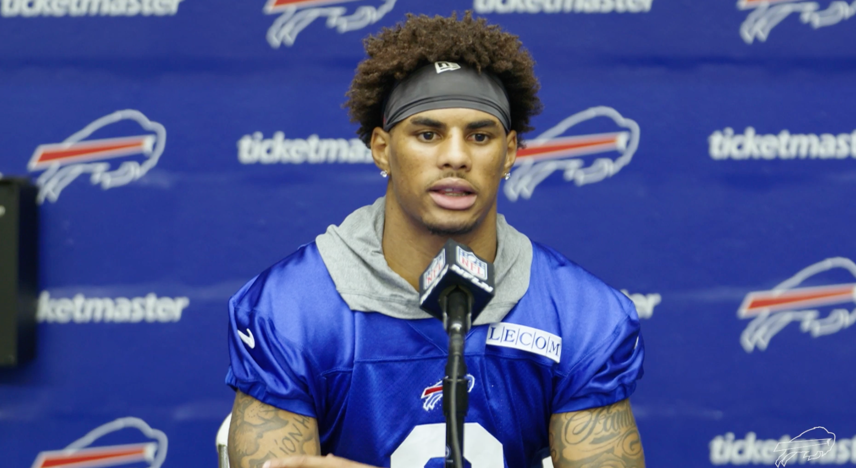 Keon Coleman speaks with the media