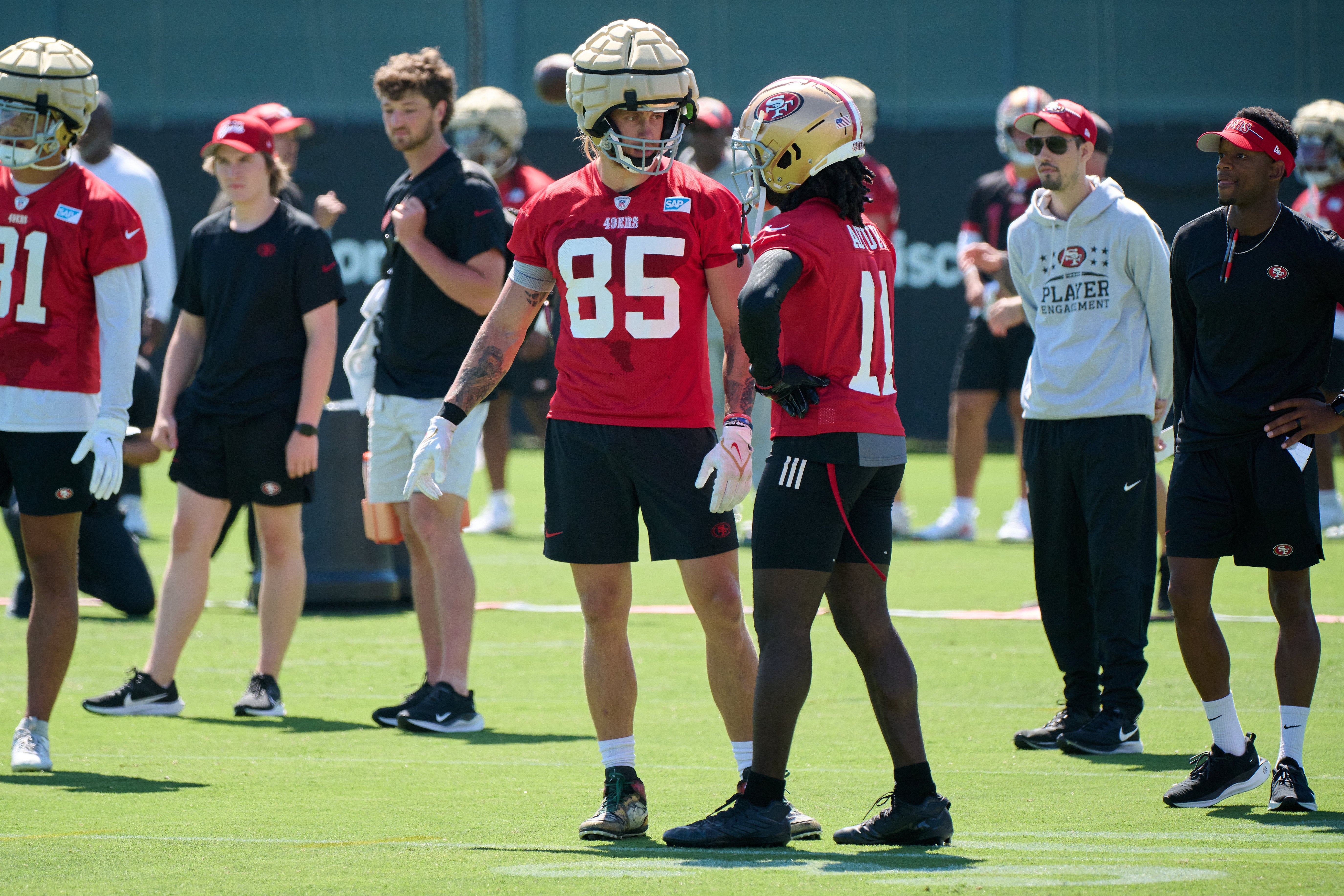 Jul 27, 2023; Santa Clara, CA, USA; San Francisco 49ers tight end George Kittle (85) talks with wide receiver Brandon Aiyuk (11) on the field during training camp at the SAP Performance Facility.
