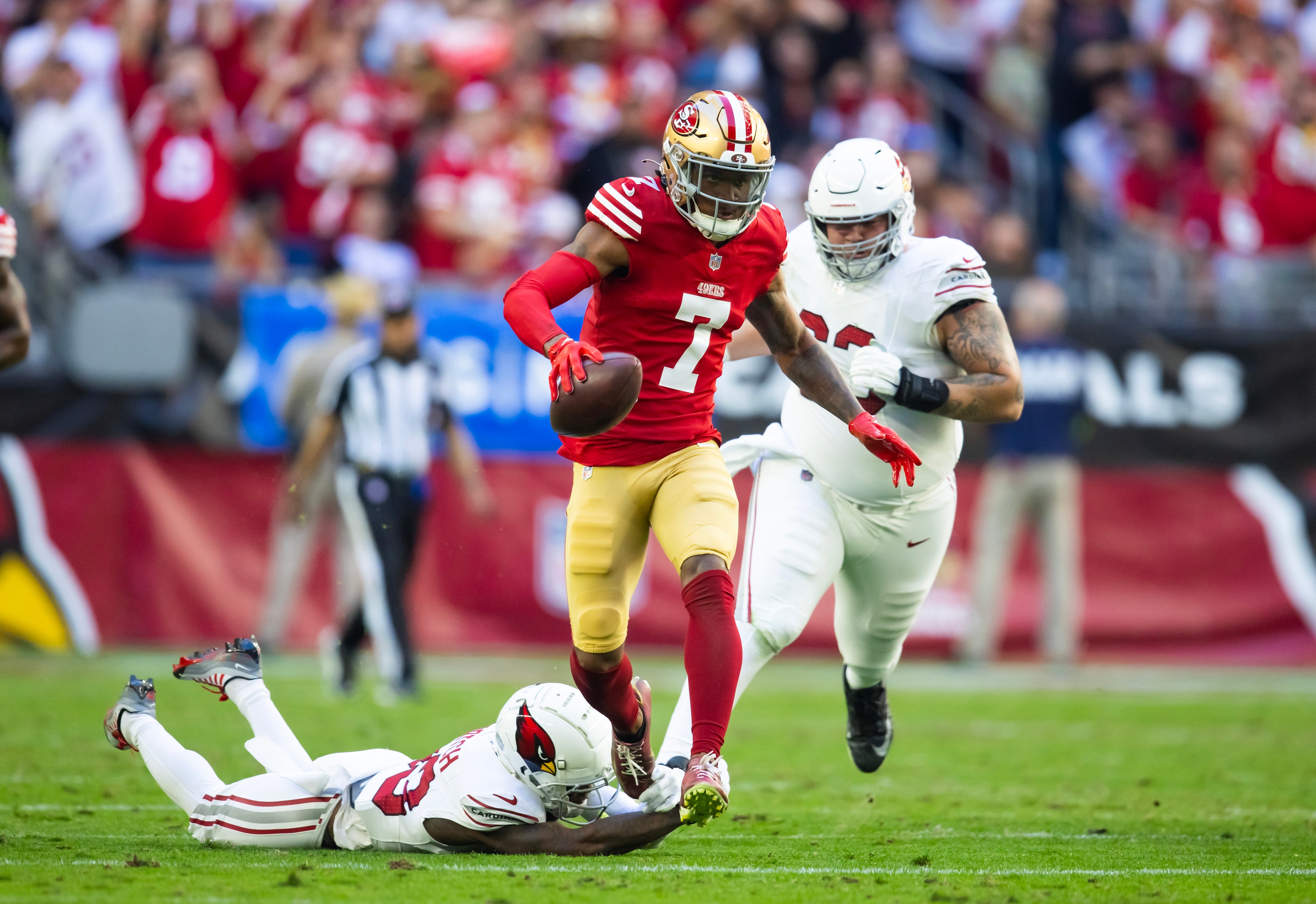 Dec 17, 2023; Glendale, Arizona, USA; San Francisco 49ers cornerback Charvarius Ward (7) runs back an interceptions for a touchdown during the first quarter against the Arizona Cardinals at State Farm Stadium.