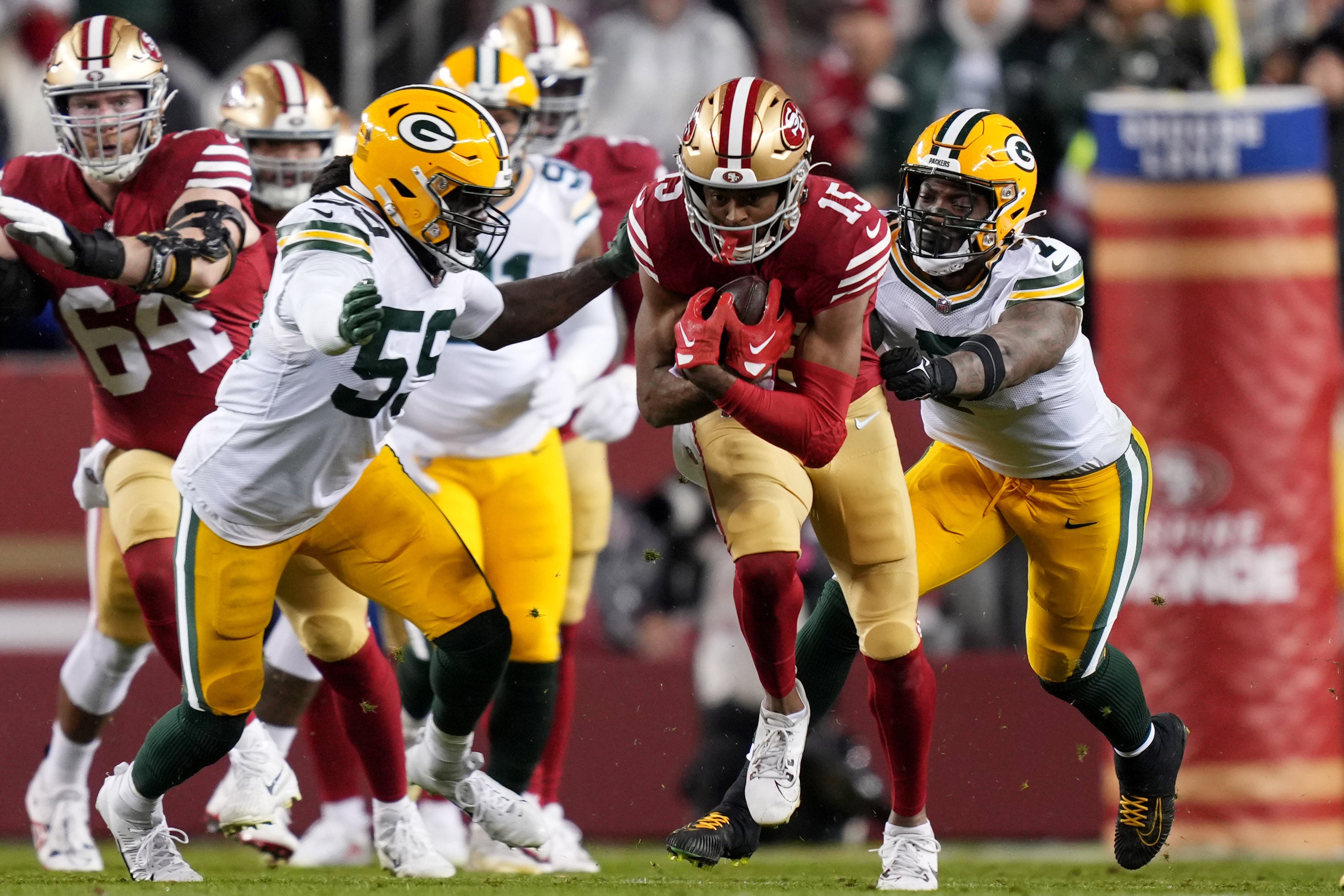 January 20, 2024; Santa Clara, CA, USA; San Francisco 49ers wide receiver Jauan Jennings (15) runs against Green Bay Packers linebacker De'Vondre Campbell (59) and linebacker Quay Walker (7) during the second quarter in a 2024 NFC divisional round game at Levi's Stadium.