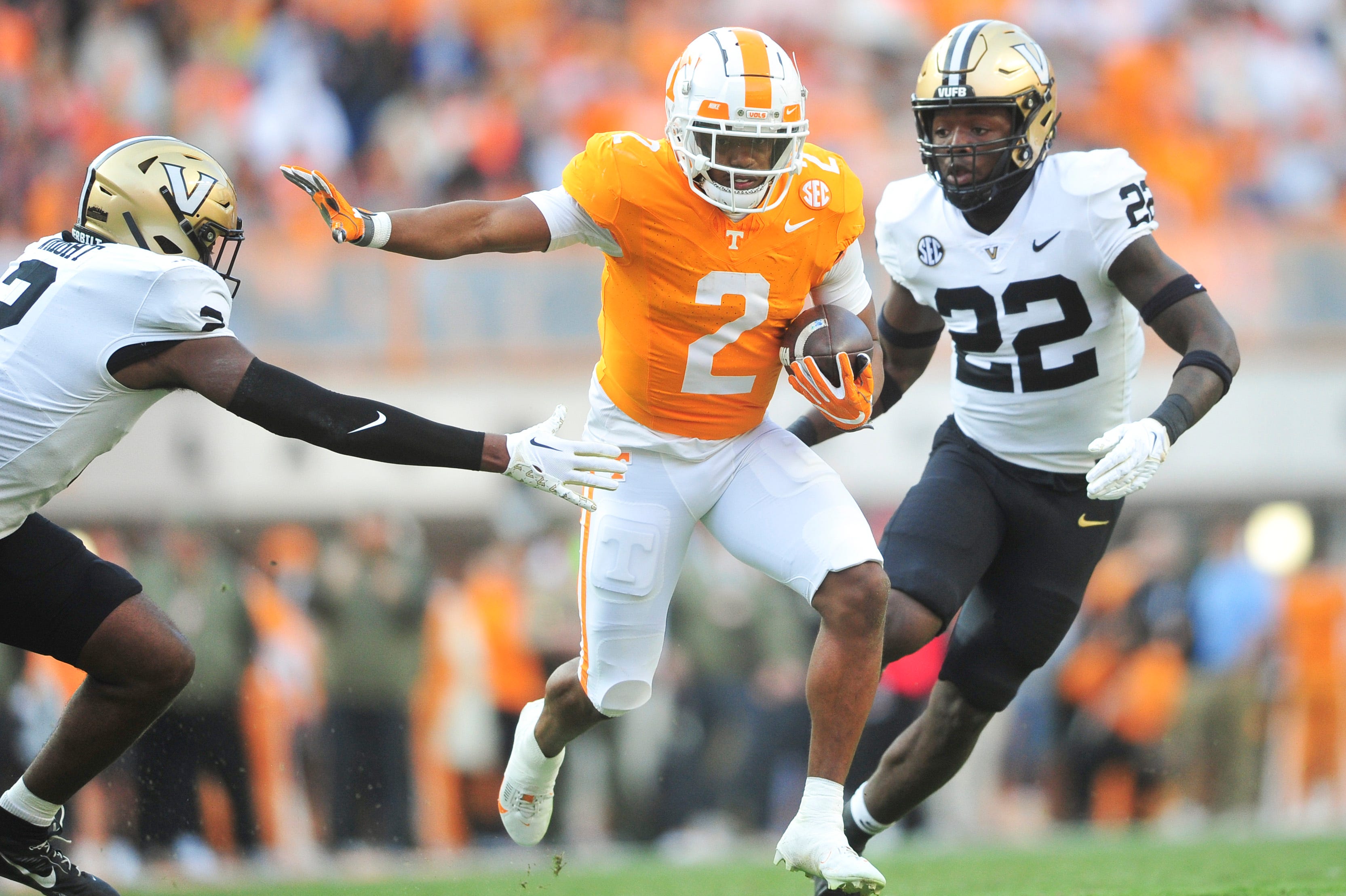 Tennessee running back Jabari Small (2) runs the ball while defended by Vanderbilt safety De Rickey Wright (2) and Vanderbilt linebacker Bryce Cowan (22) during a football game between Tennessee and Vanderbilt at Neyland Stadium in Knoxville, Tenn., on Saturday, Nov. 25, 2023.