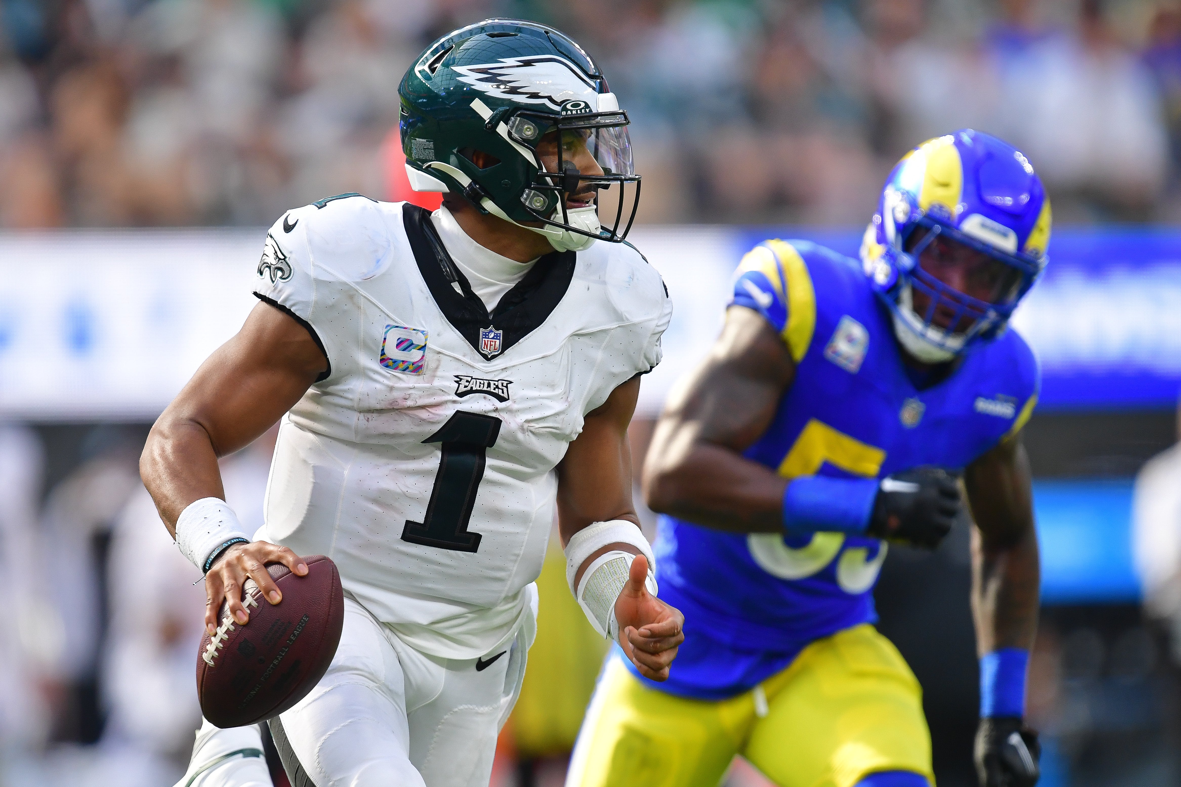 Philadelphia Eagles quarterback Jalen Hurts (1) runs the ball ahead of Los Angeles Rams linebacker Ernest Jones (53) during the second half at SoFi Stadium.