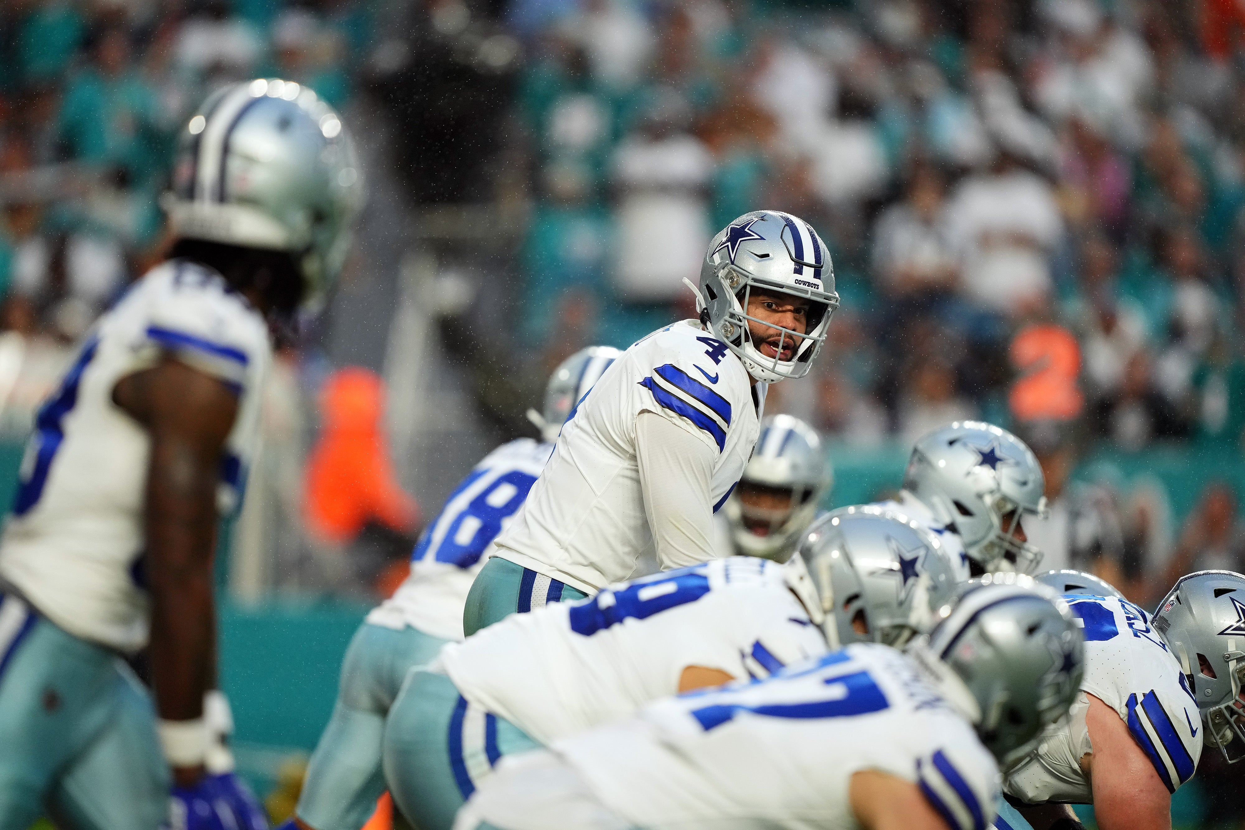 Dallas Cowboys quarterback Dak Prescott (4) looks over the offensive line during the first half against the Miami Dolphins at Hard Rock Stadium.