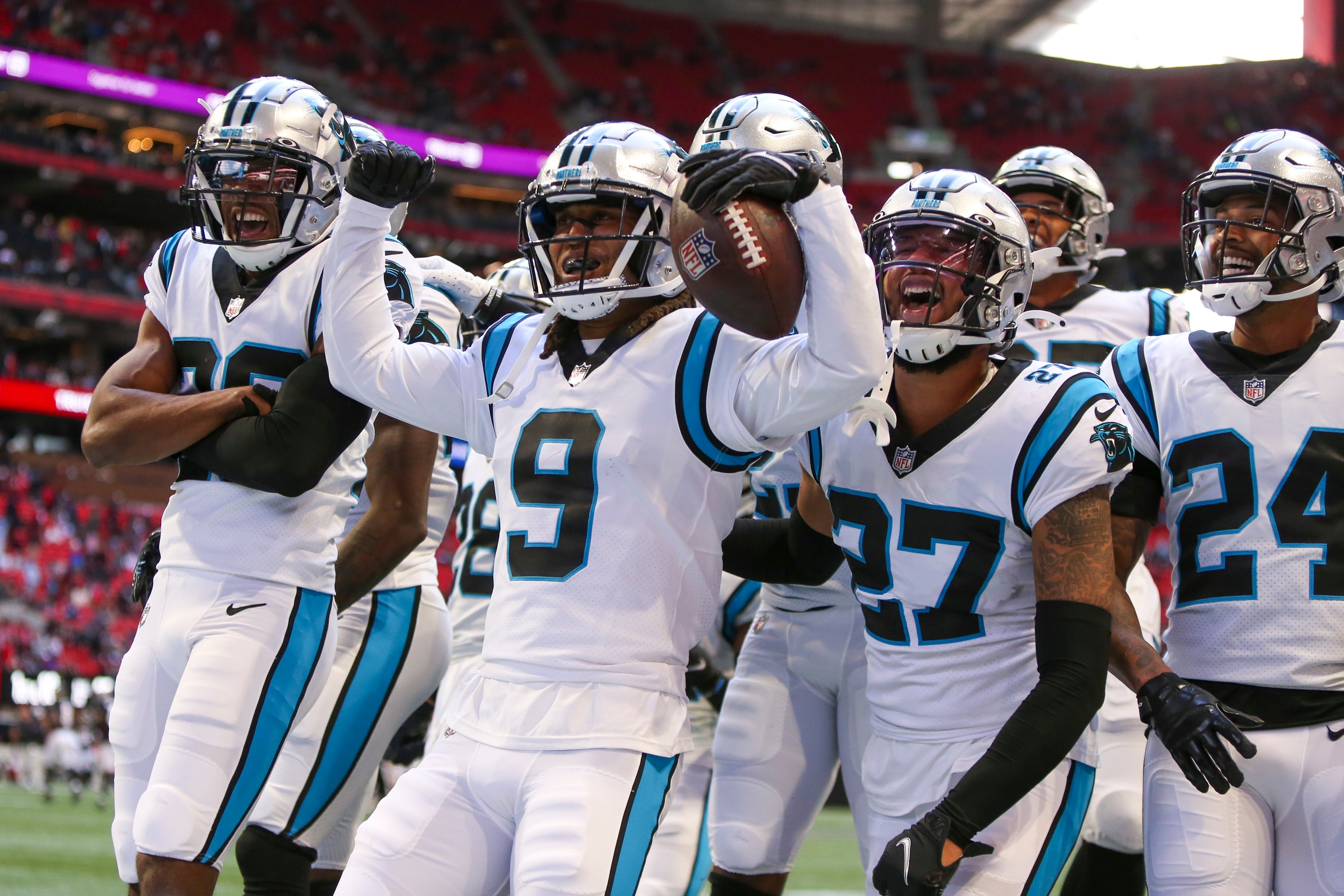 Oct 31, 2021; Atlanta, Georgia, USA; Carolina Panthers cornerback Stephon Gilmore (9) celebrates after an interception with teammates against the Atlanta Falcons in the fourth quarter at Mercedes-Benz Stadium. Mandatory Credit: Brett Davis-USA TODAY Sports