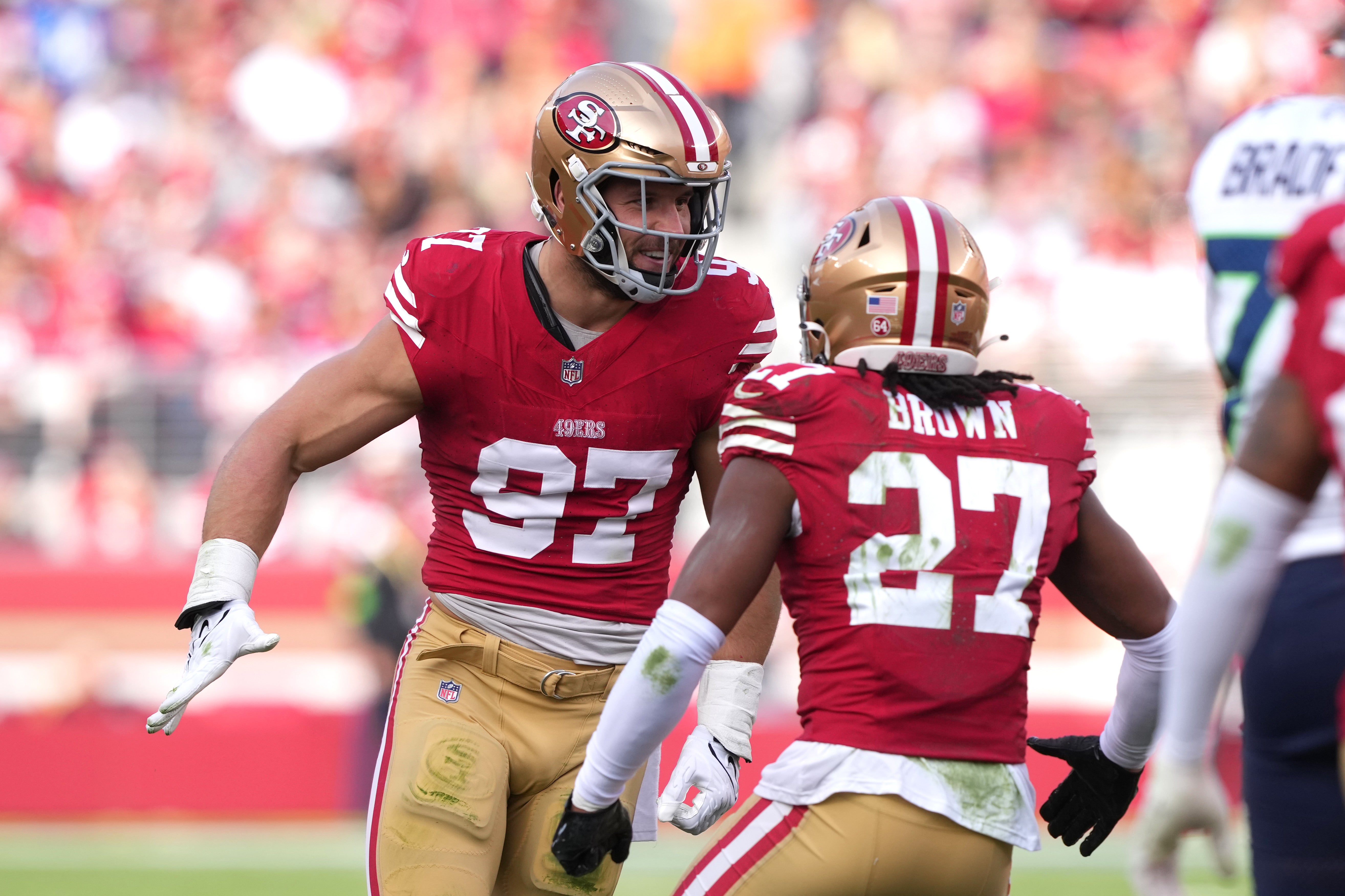 Dec 10, 2023; Santa Clara, California, USA; San Francisco 49ers defensive end Nick Bosa (97) celebrates with safety Ji'Ayir Brown (27) after a tackle against the Seattle Seahawks during the first quarter at Levi's Stadium.