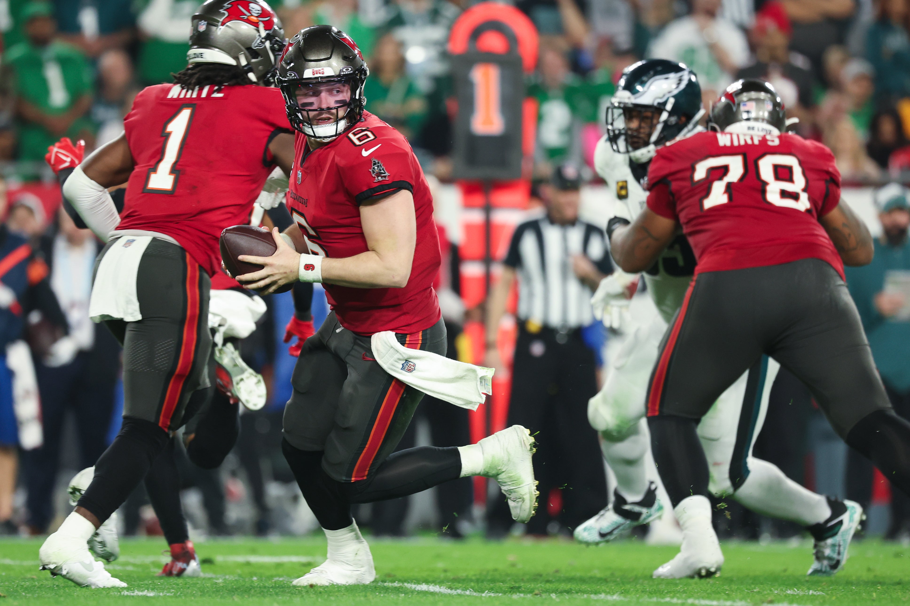 Jan 15, 2024; Tampa, Florida, USA; Tampa Bay Buccaneers quarterback Baker Mayfield (6) scrambles during the first half of a 2024 NFC wild card game against the Philadelphia Eagles at Raymond James Stadium.