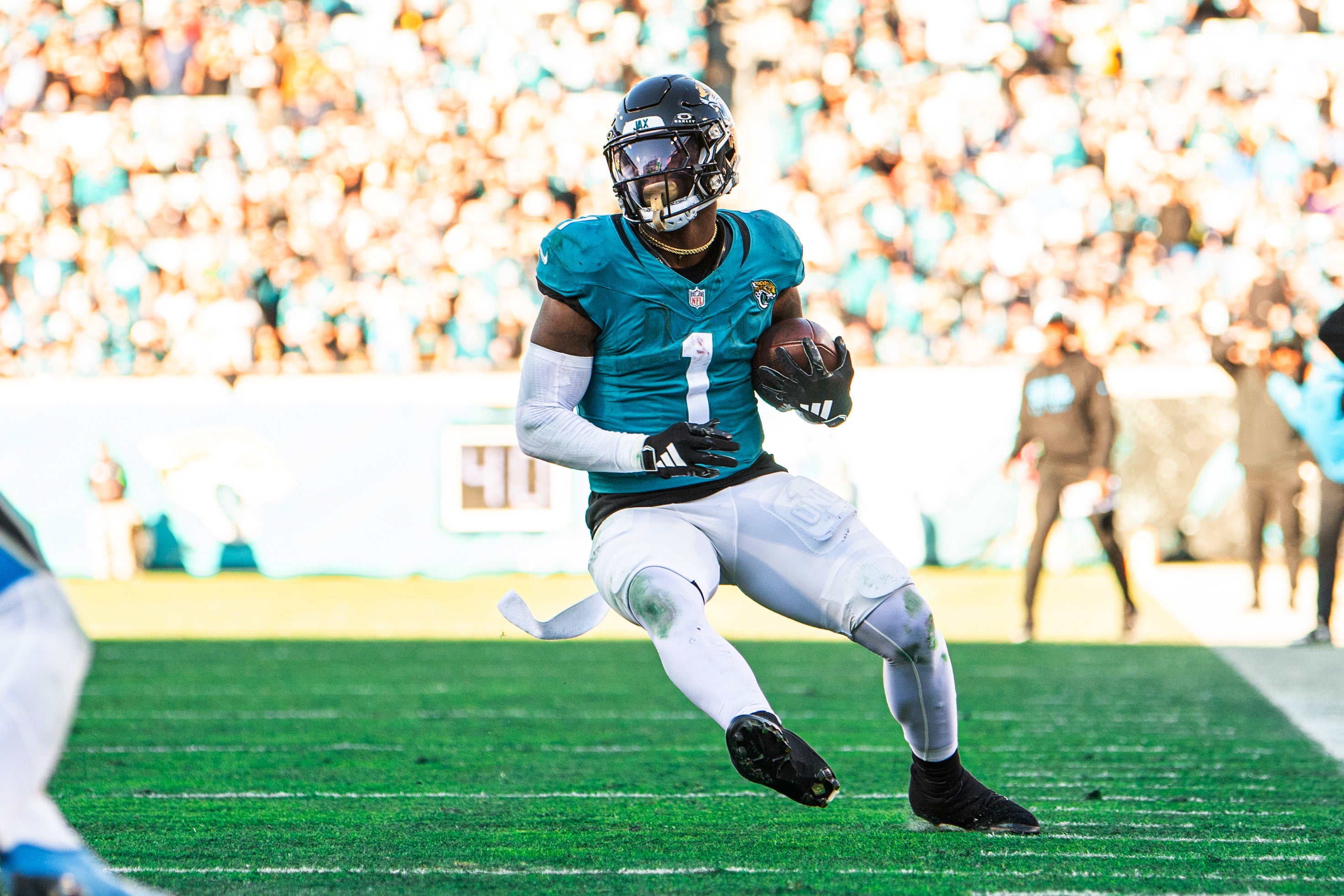 Dec 31, 2023; Jacksonville, Florida, USA; Jacksonville Jaguars running back Travis Etienne Jr. (1) runs the ball against Carolina Panthers linebacker Kamu Grugier-Hill (54) in the fourth quarter at EverBank Stadium.