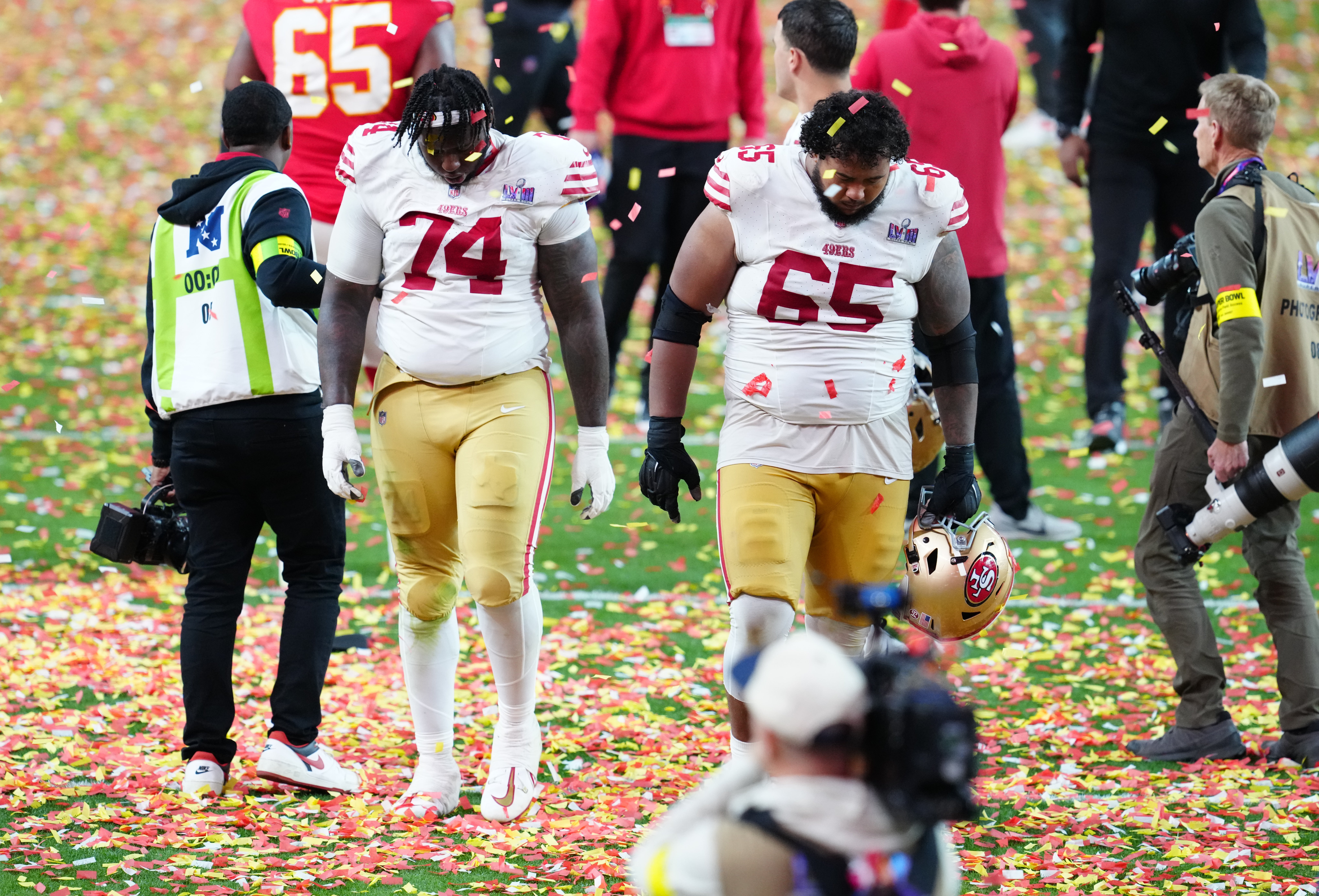 Feb 11, 2024; Paradise, Nevada, USA; San Francisco 49ers offensive tackle Spencer Burford (74) and San Francisco 49ers guard Aaron Banks (65) leave the field after losing to the Kansas City Chiefs during overtime in Super Bowl LVIII at Allegiant Stadium.