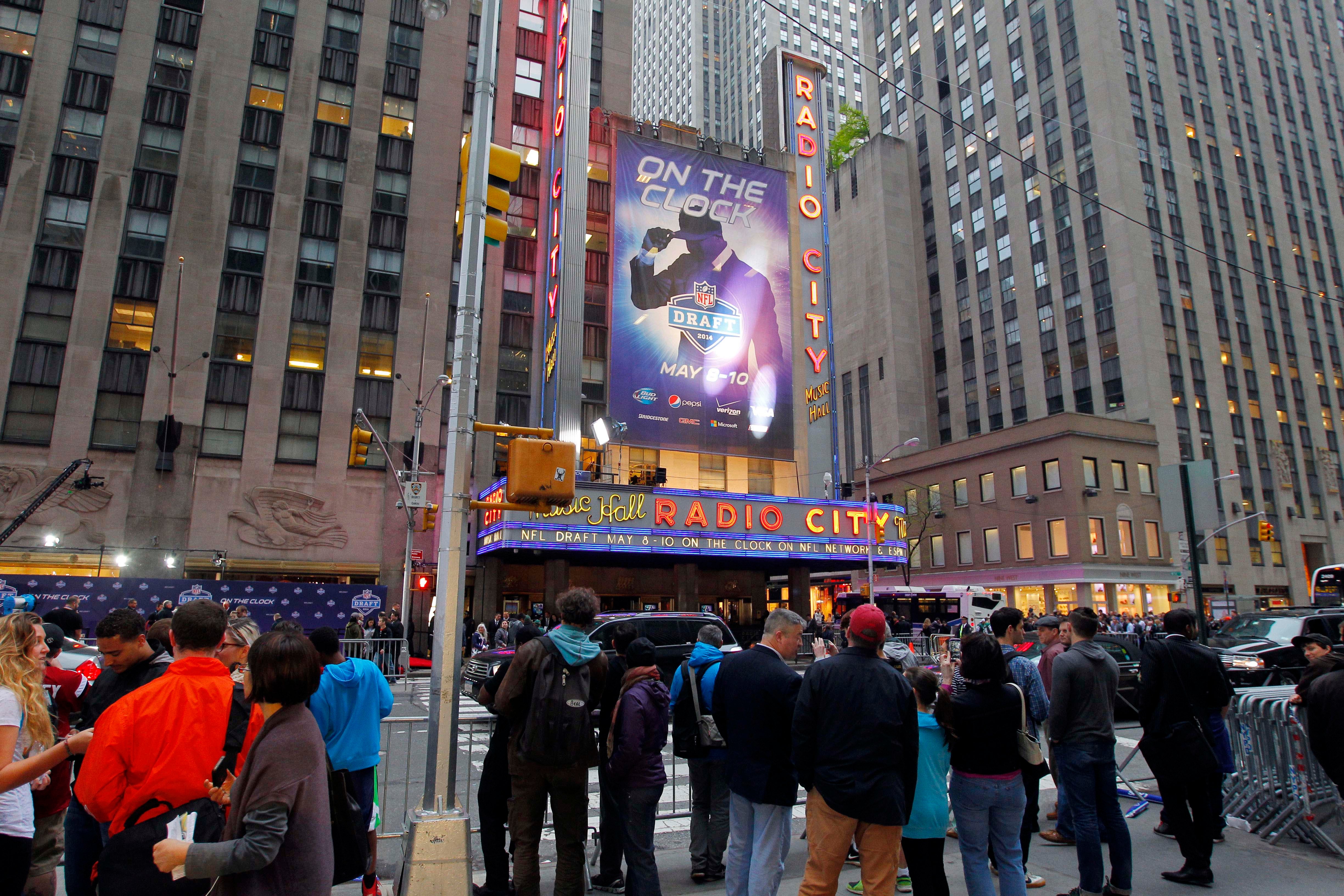 Football fans enjoy the festivities outside of Radio City Music Hall before the 2014 NFL Draft.