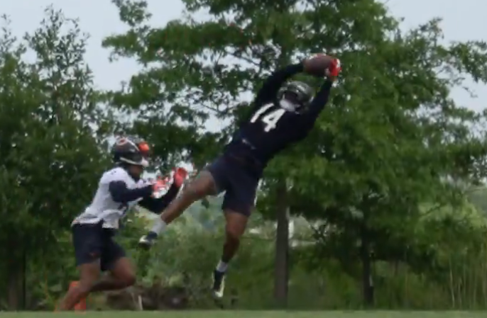 Bears tight end Gerald Everett makes a leaping catch over Kyler Gordon at OTAs.