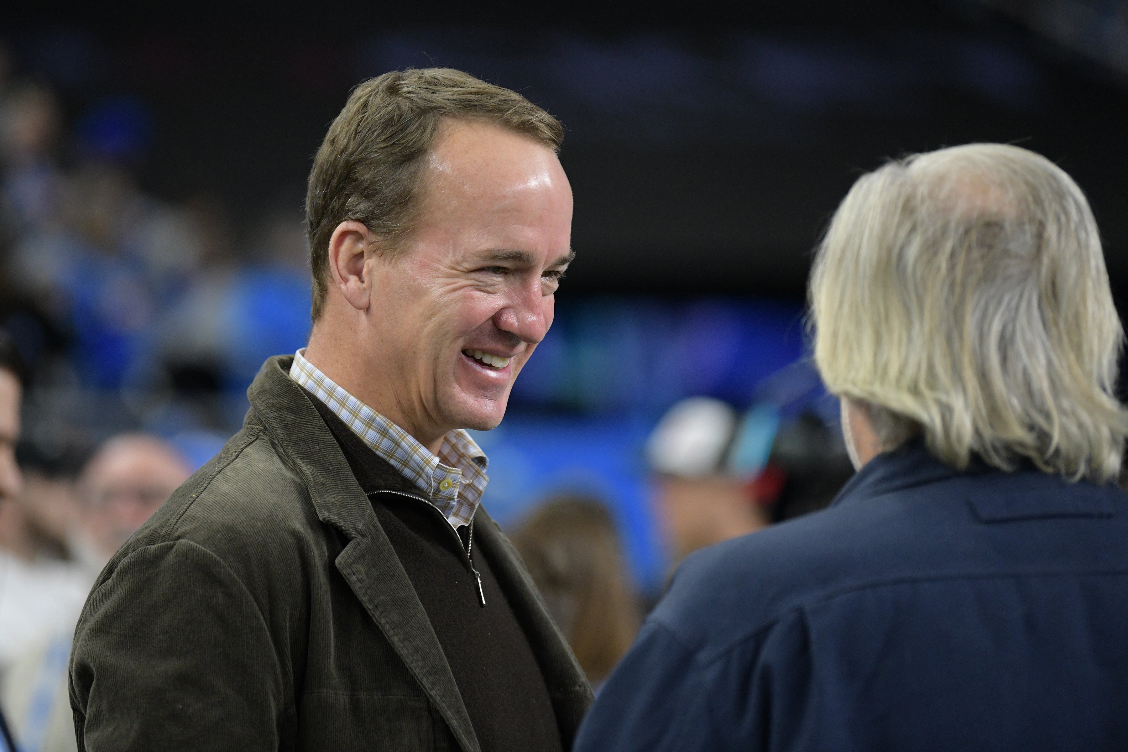 Jan 21, 2024; Detroit, Michigan, USA; NFL former player Peyton Manning talks with actor Jeff Daniels before a 2024 NFC divisional round game between the Detroit Lions and the Tampa Bay Buccaneers at Ford Field.