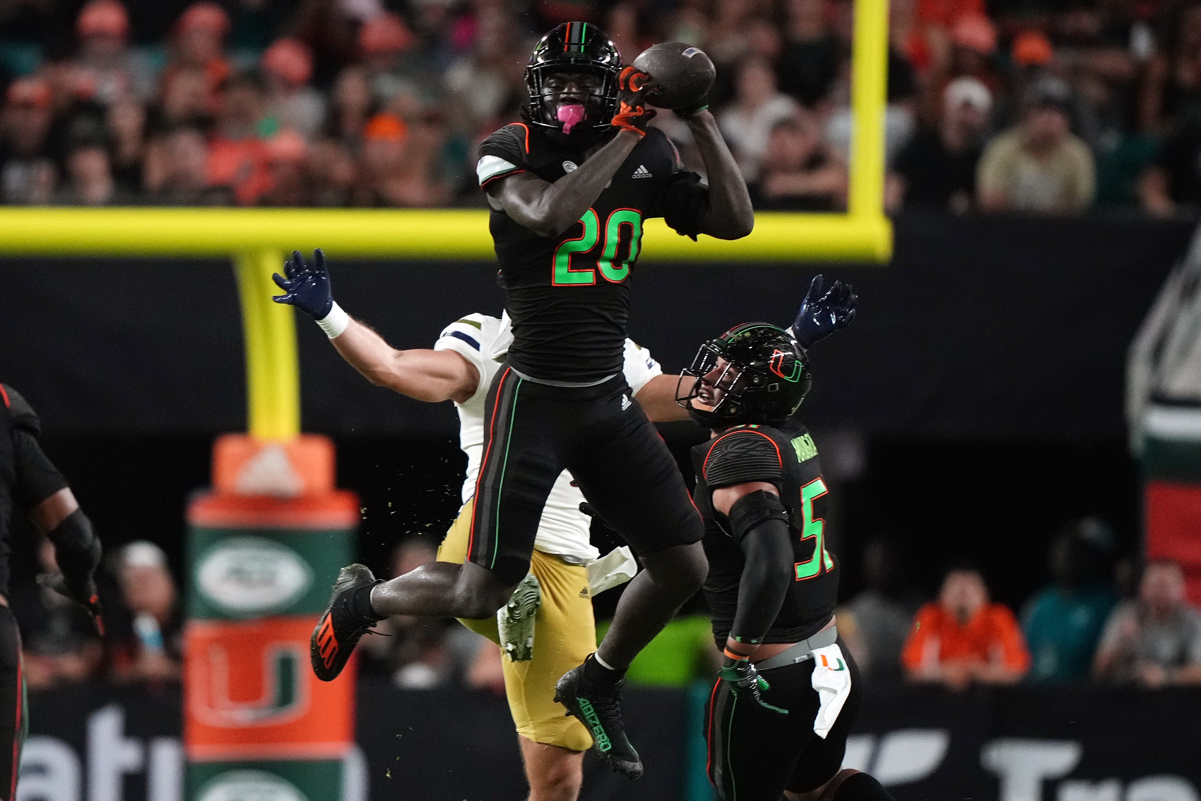 Oct 7, 2023; Miami Gardens, Florida, USA; Miami Hurricanes safety James Williams (20) intercepts a pass against the Georgia Tech Yellow Jackets in the second half at Hard Rock Stadium.