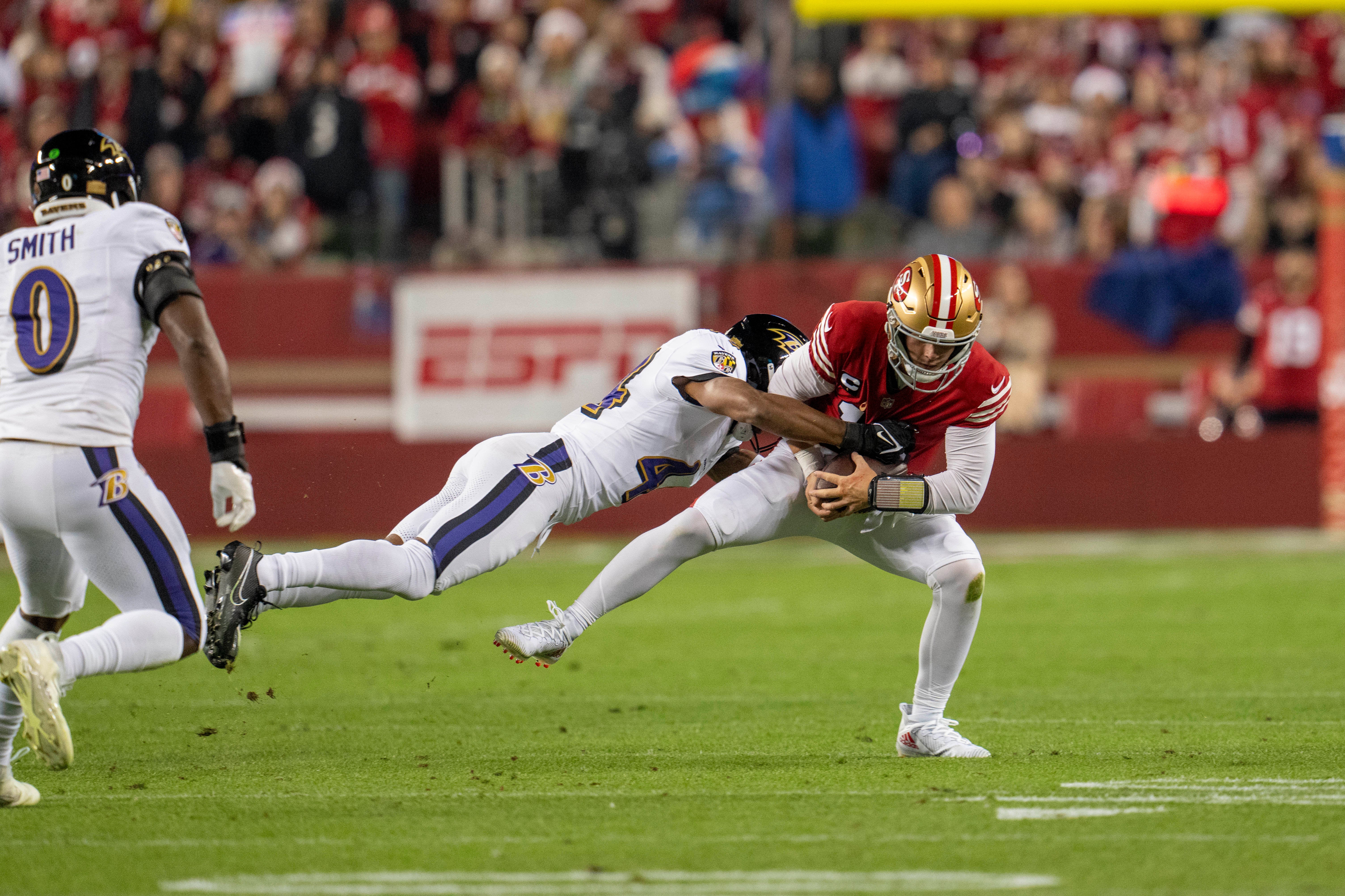 Dec 25, 2023; Santa Clara, California, USA; San Francisco 49ers quarterback Brock Purdy (13) is sacked by Baltimore Ravens cornerback Marlon Humphrey (44) during the first quarter at Levi's Stadium.