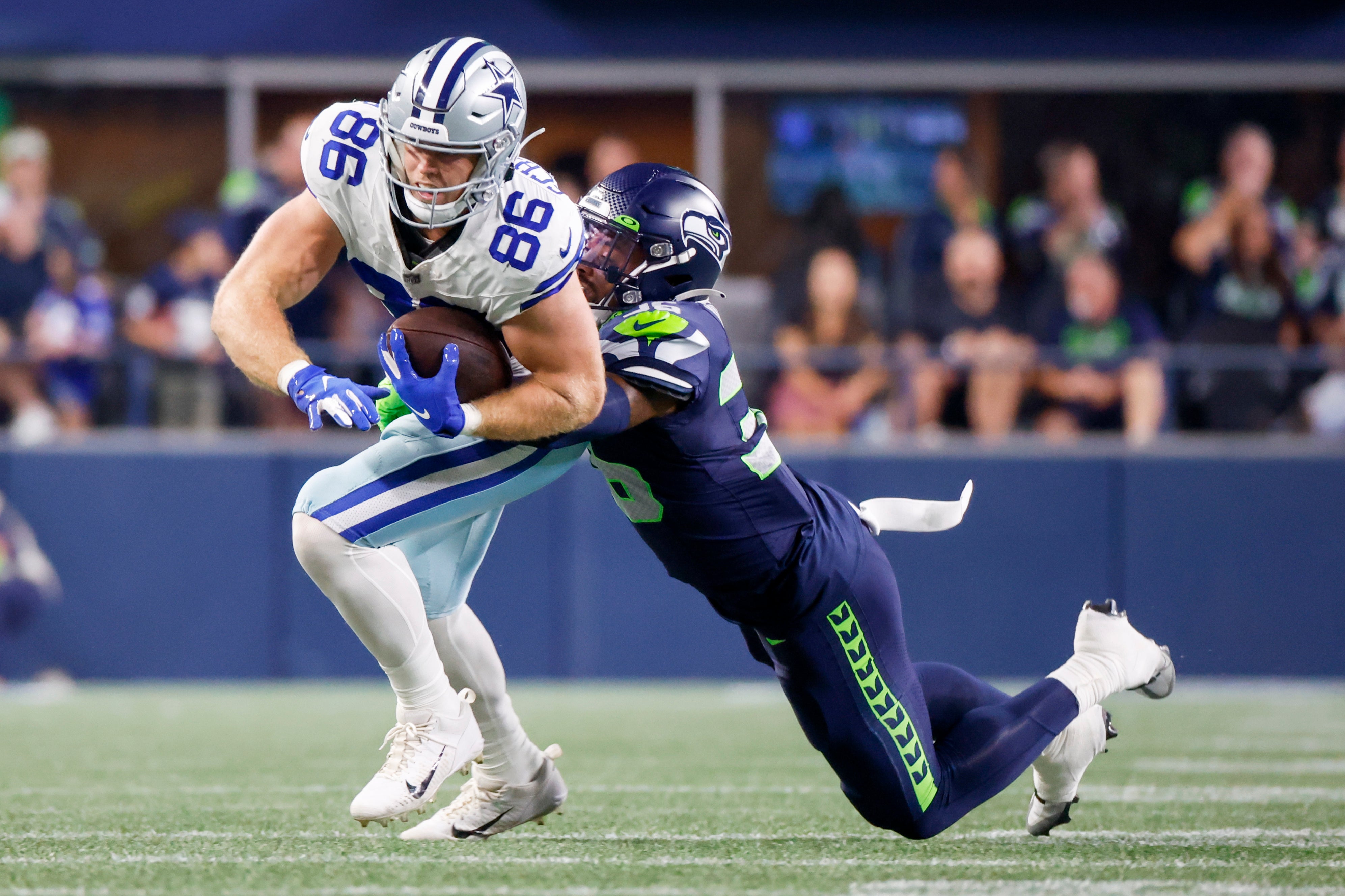 Dallas Cowboys tight end Luke Schoonmaker (86) runs for yards after the catch against Seattle Seahawks safety Christian Young (36) during the third quarter at Lumen Field.