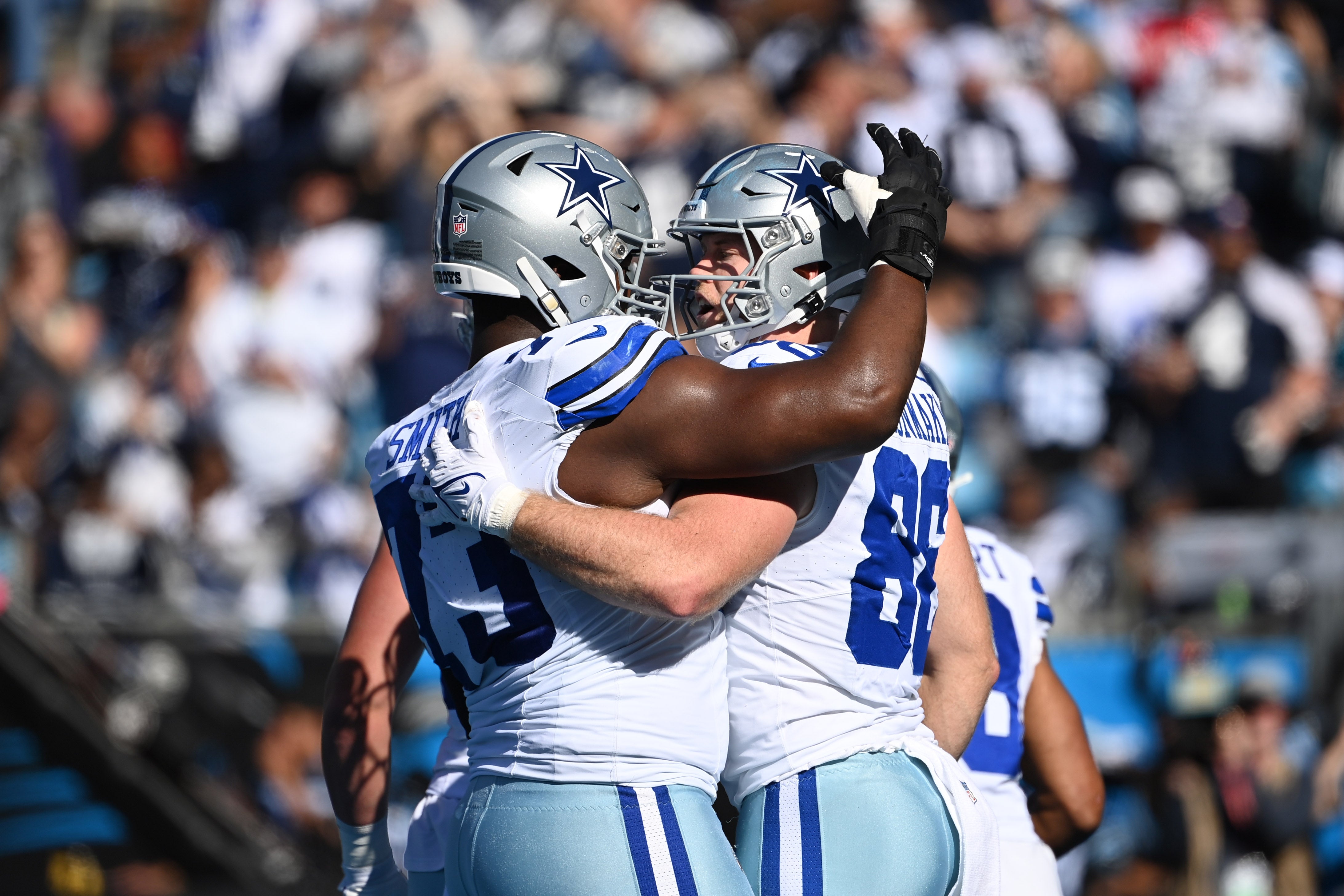 Dallas Cowboys tight end Luke Schoonmaker (86) celebrates with offensive tackle Tyler Smith (73) after scoring a touchdown in the first quarter at Bank of America Stadium.