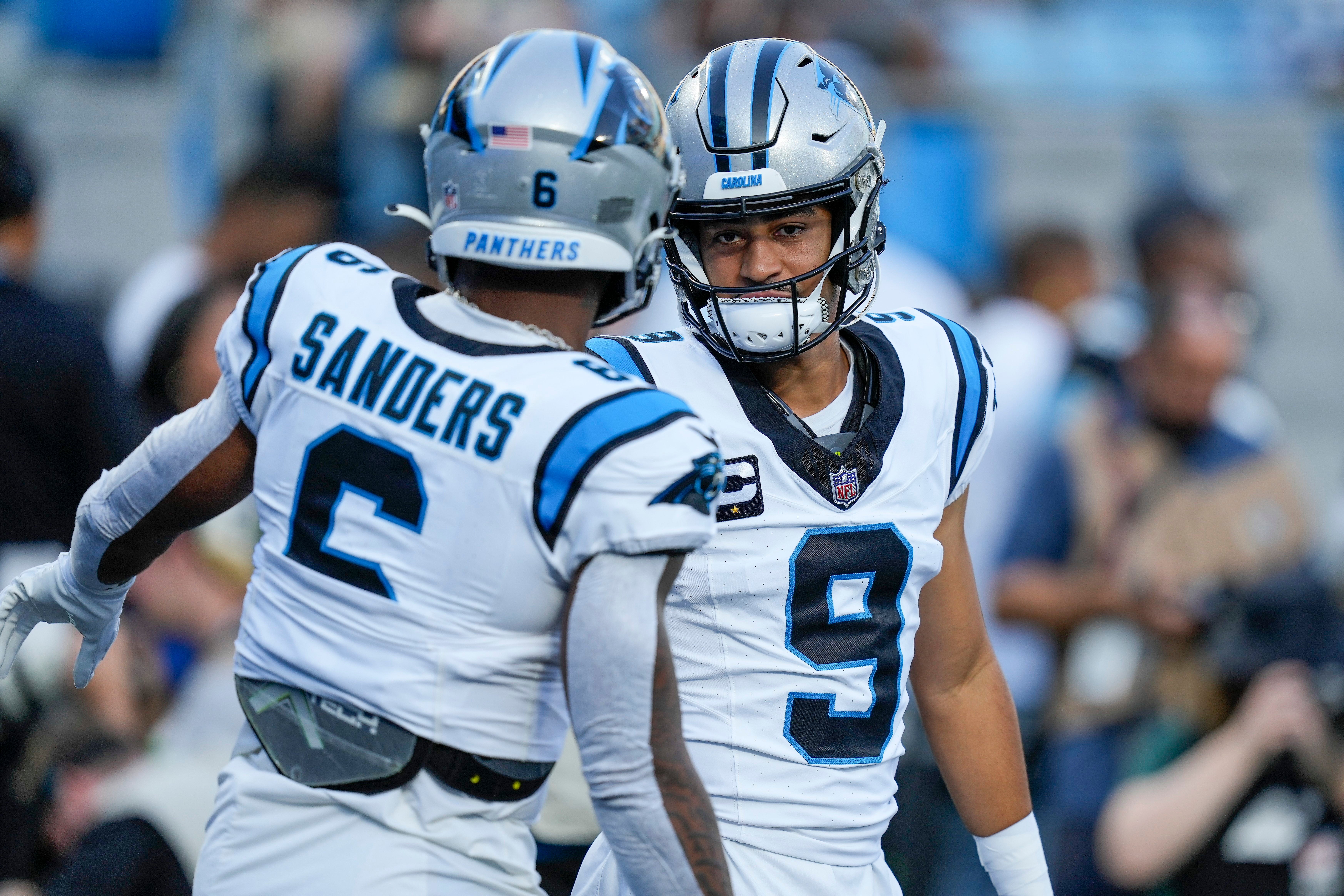 Sep 18, 2023; Charlotte, North Carolina, USA; Carolina Panthers running back Miles Sanders (6) and quarterback Bryce Young (9) during pregame warm ups against the New Orleans Saints at Bank of America Stadium. Mandatory Credit: Jim Dedmon-USA TODAY Sports