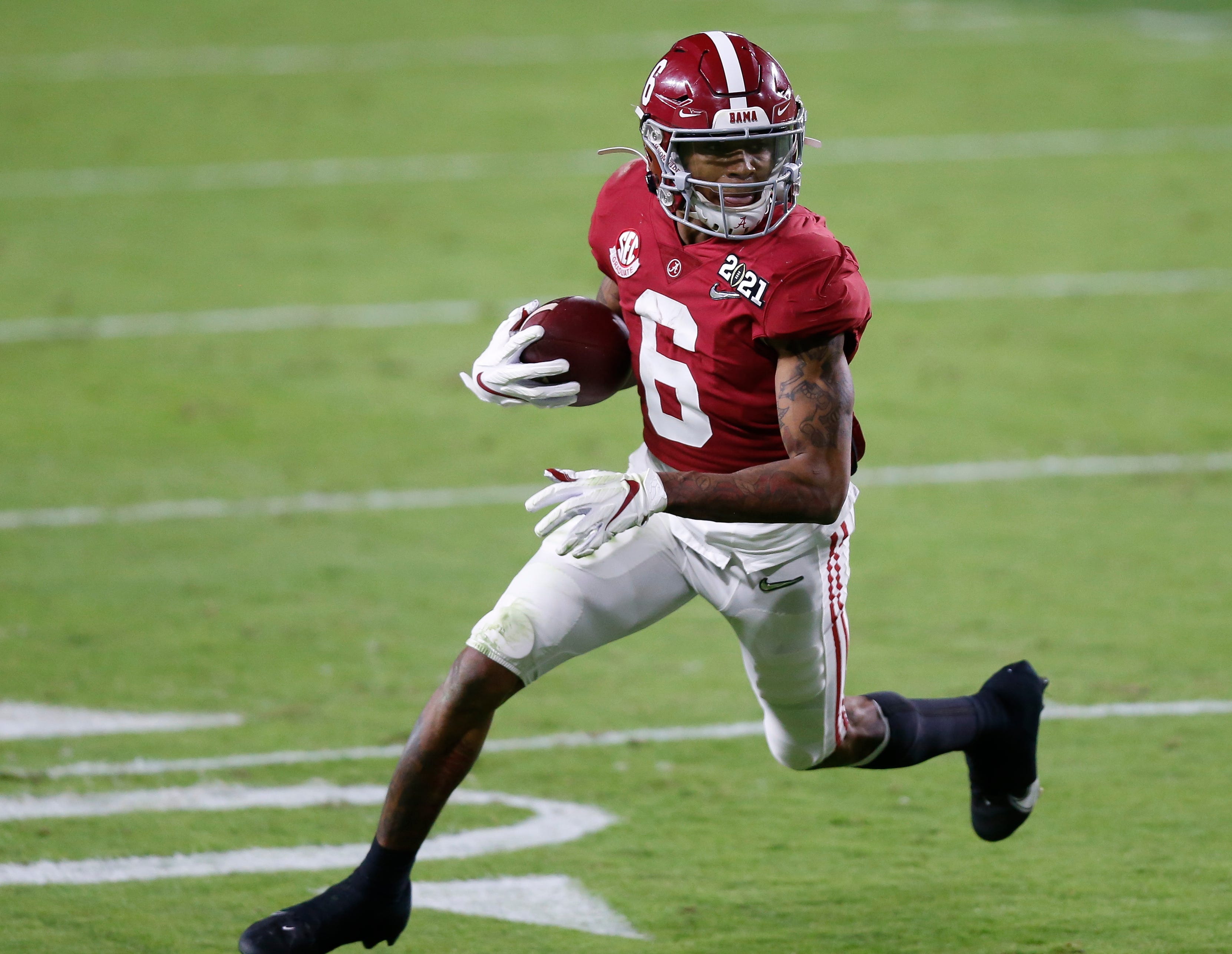 Jan. 11, 2021; Miami Gardens, Florida, USA; Alabama Crimson Tide wide receiver DeVonta Smith (6) runs for a 5-yard touchdown during the second quarter of the College Football Playoff National Championship against the Ohio State Buckeyes at Hard Rock Stadium in Miami Gardens, Fla.
