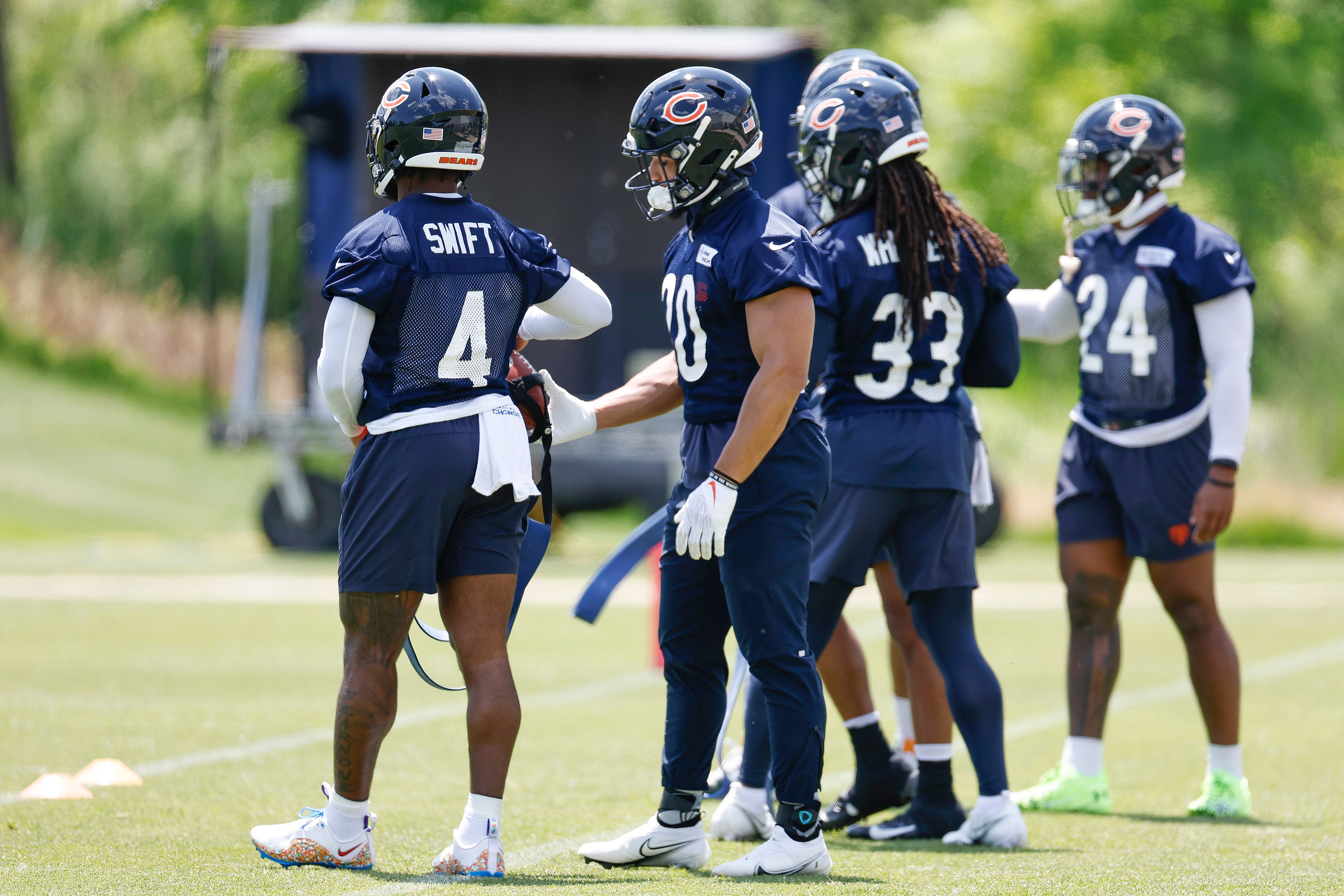 May 23, 2024; Lake Forest, IL, USA; Chicago Bears running backs warm up during organized team activities at Halas Hall.