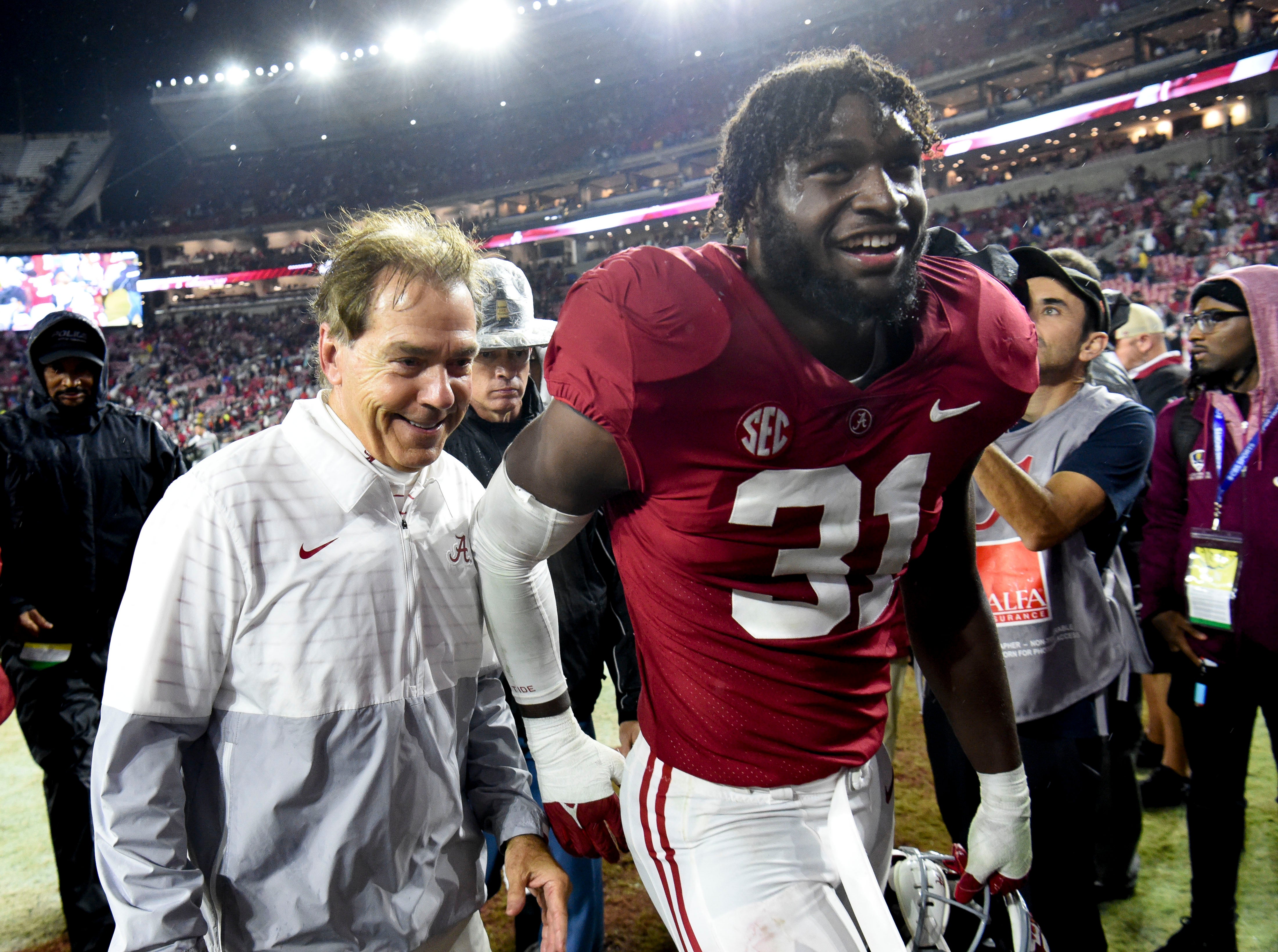 Nov 26, 2022; Tuscaloosa, Alabama, USA; Alabama Crimson Tide head coach Nick Saban and linebacker Will Anderson Jr. (31) share a smile as they leave the field after defeating the Auburn Tigers at Bryant-Denny Stadium. Alabama won 49-27. Mandatory Credit: Gary Cosby Jr.-USA TODAY Sports