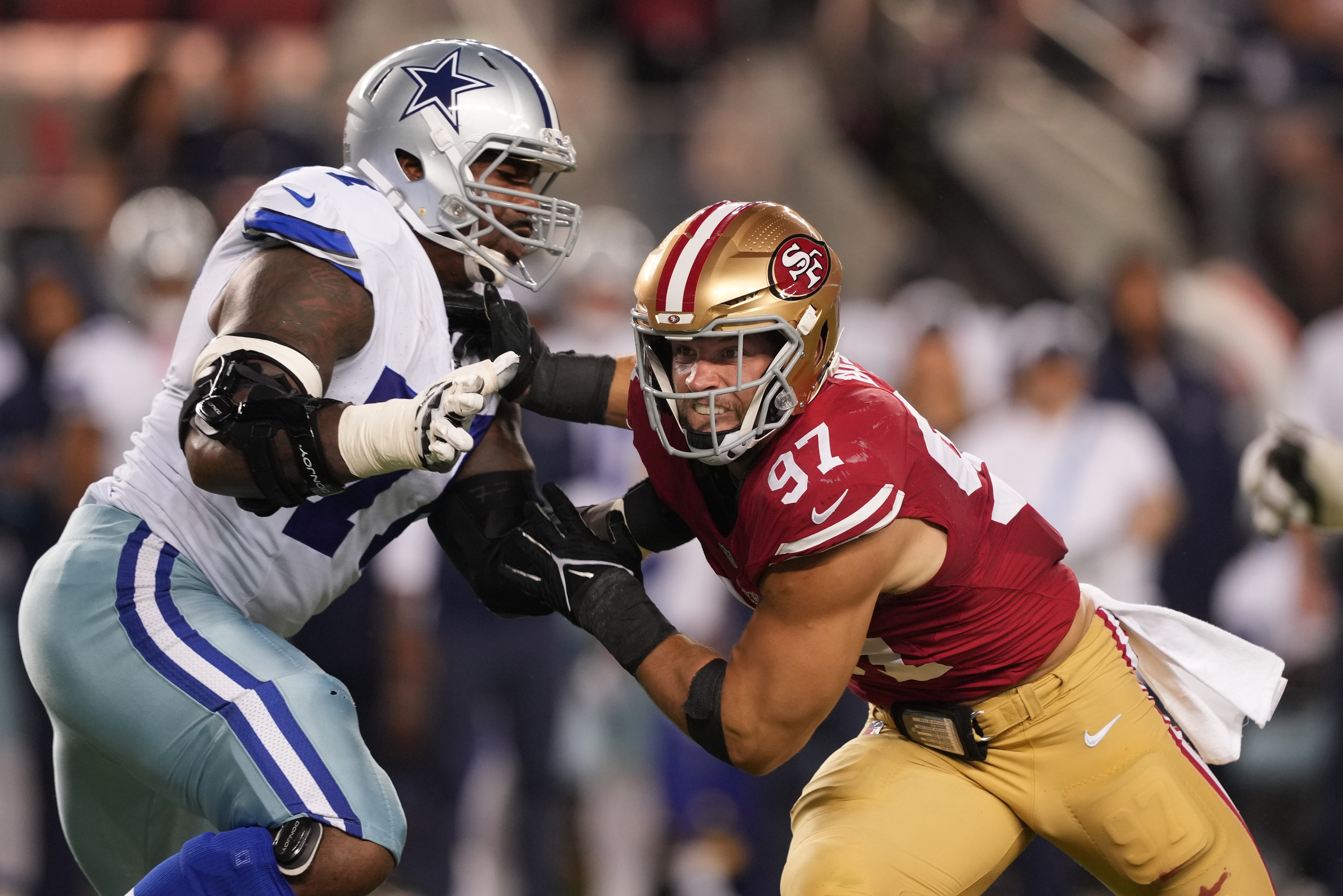 San Francisco 49ers defensive end Nick Bosa (97) rushes against Dallas Cowboys offensive tackle Tyron Smith (left) during the second quarter at Levi's Stadium.