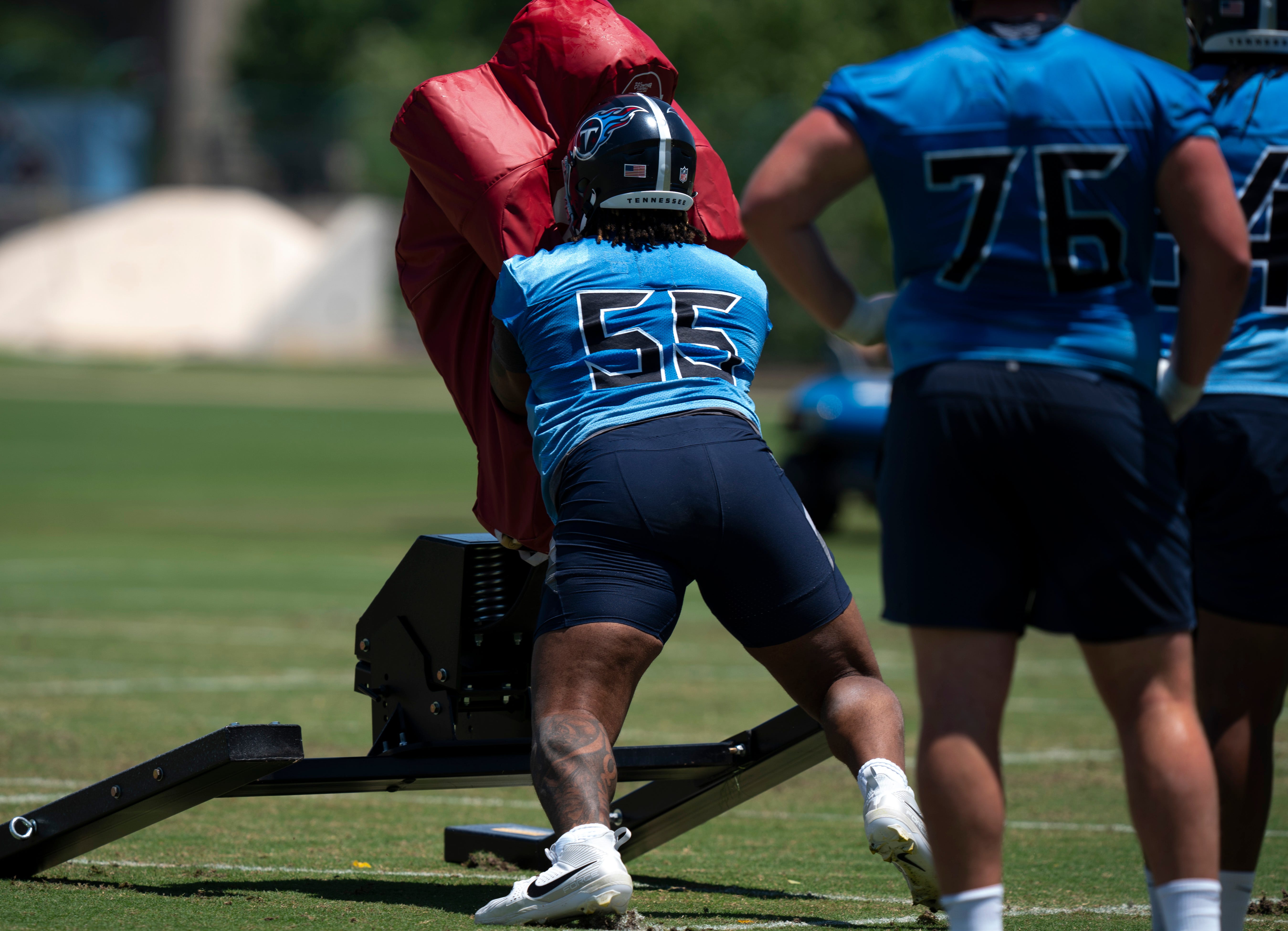 Tackle JC Latham (55) takes on the sled during Tennessee Titans practice at Ascension Saint Thomas Sports Park in Nashville, Tenn., Tuesday, May 21, 2024.