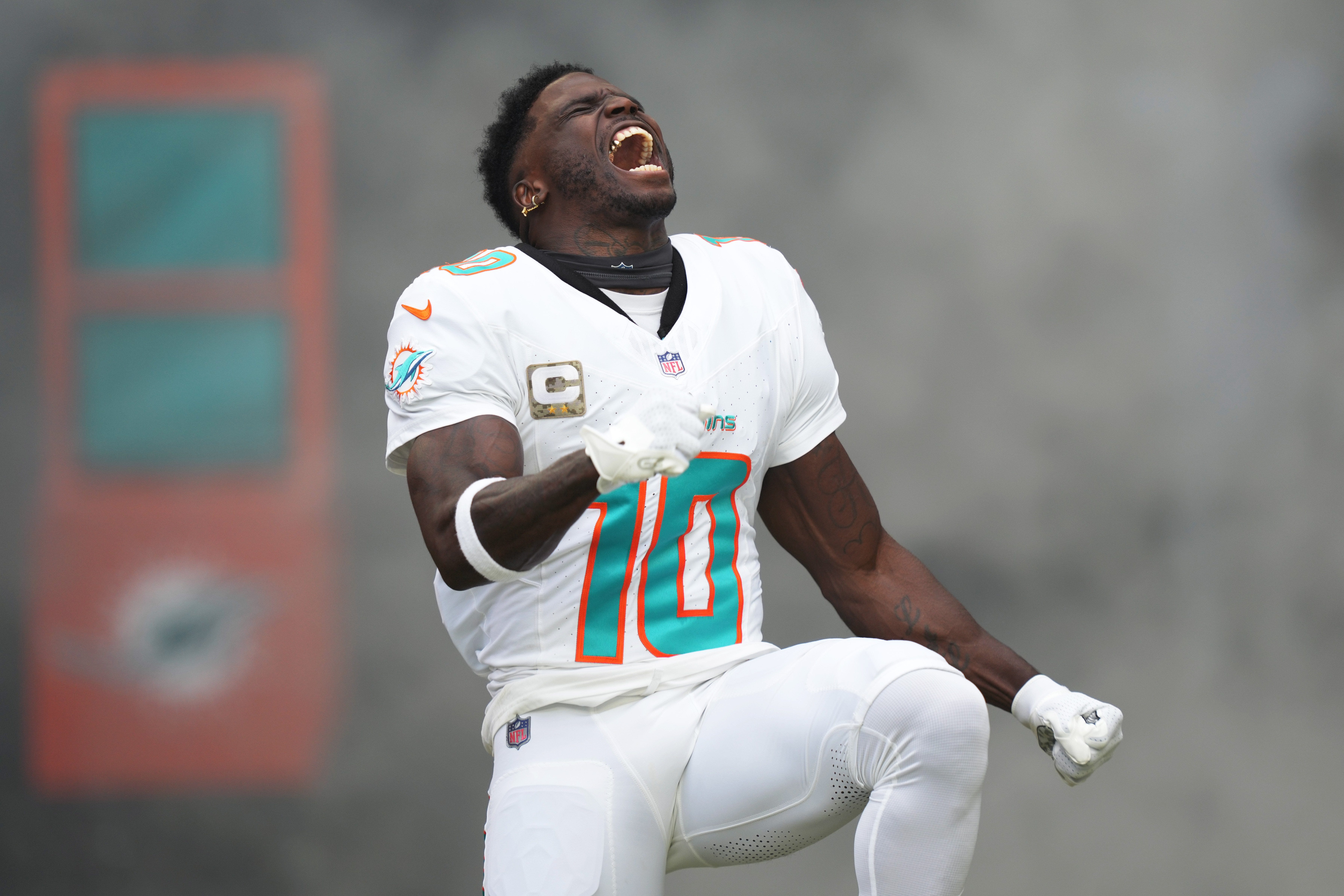 Miami Dolphins wide receiver Tyreek Hill (10) runs onto the field during pregame ceremonies of an NFL game against the Las Vegas Raiders at Hard Rock Stadium in Miami Gardens,