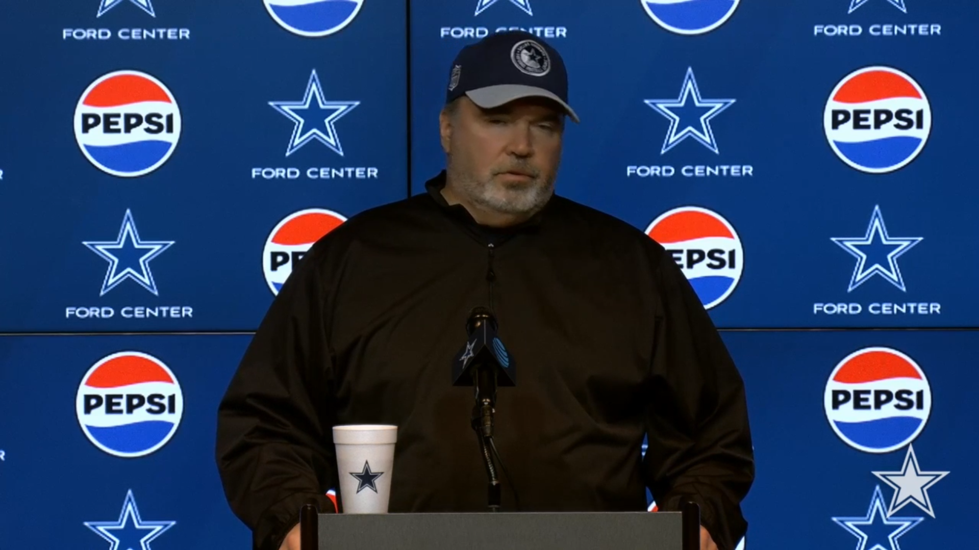 Mike McCarthy talks to reporters during Dallas Cowboys OTAs.