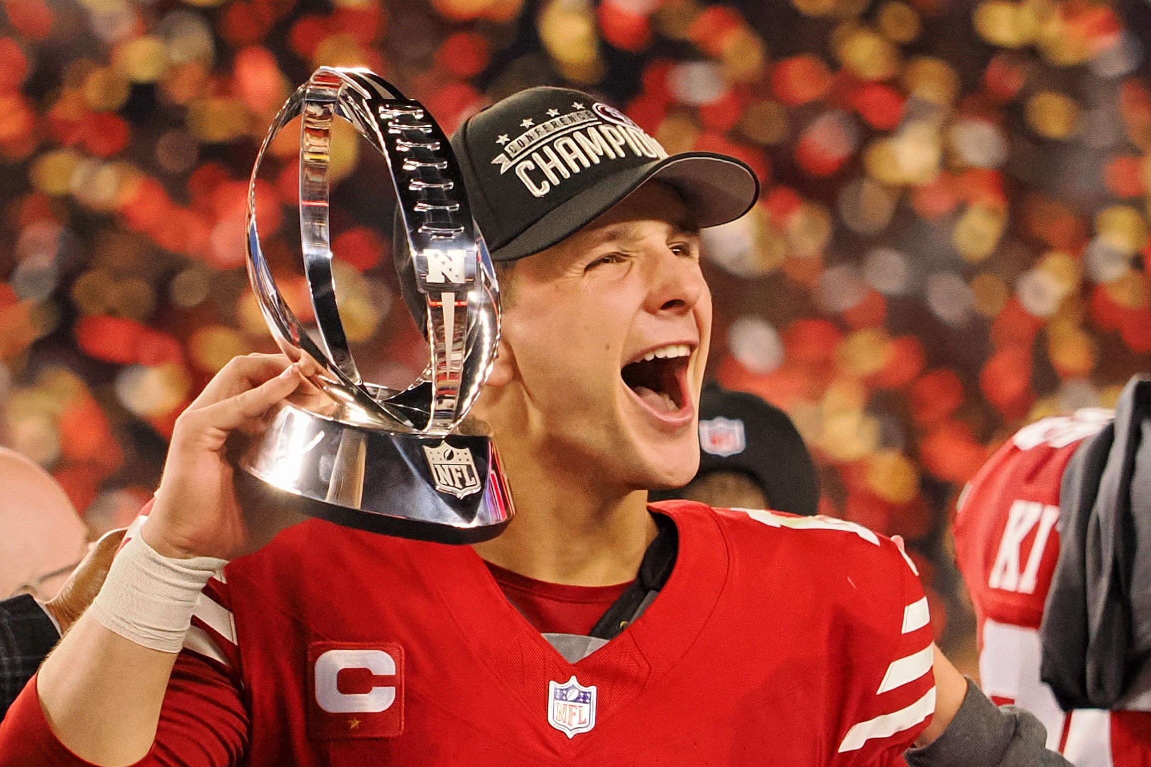 Jan 28, 2024; Santa Clara, California, USA; San Francisco 49ers quarterback Brock Purdy (13) holds the George Halas Trophy while after winning the NFC Championship football game against the Detroit Lions at Levi's Stadium.