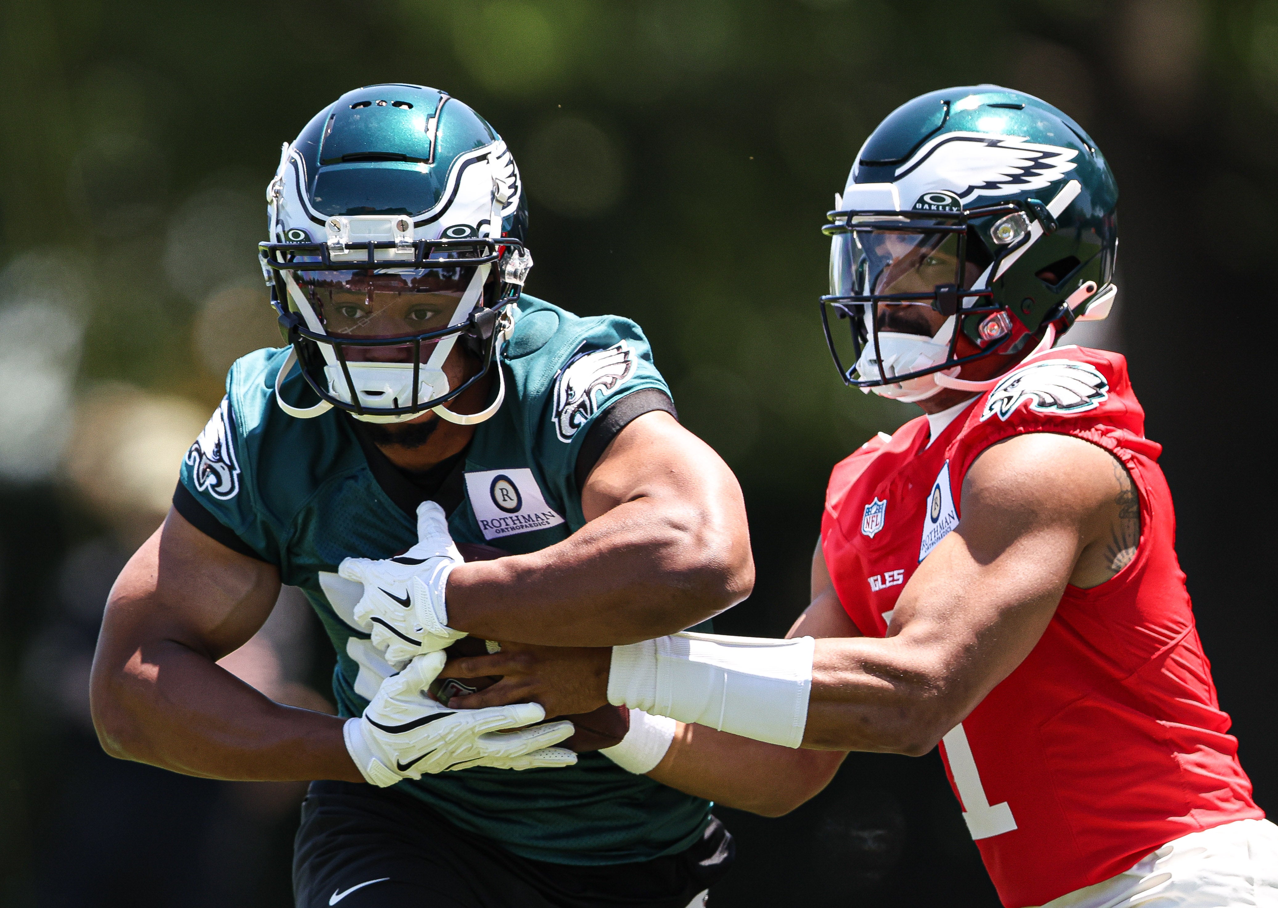 Philadelphia Eagles quarterback Jalen Hurts (1) hands off to running back Saquon Barkley (26) during practice at NovaCare Complex.
